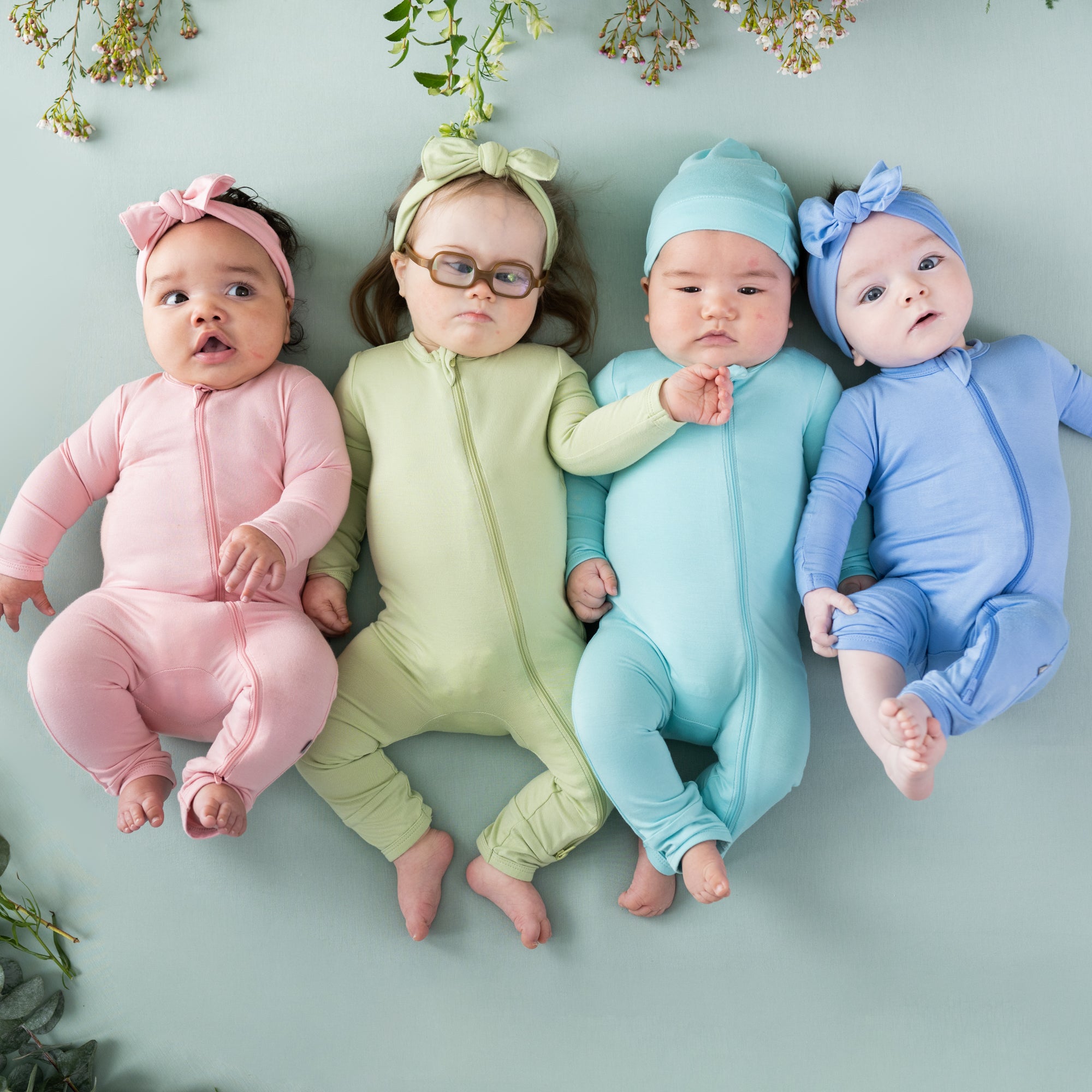 Babies wearing zippered rompers