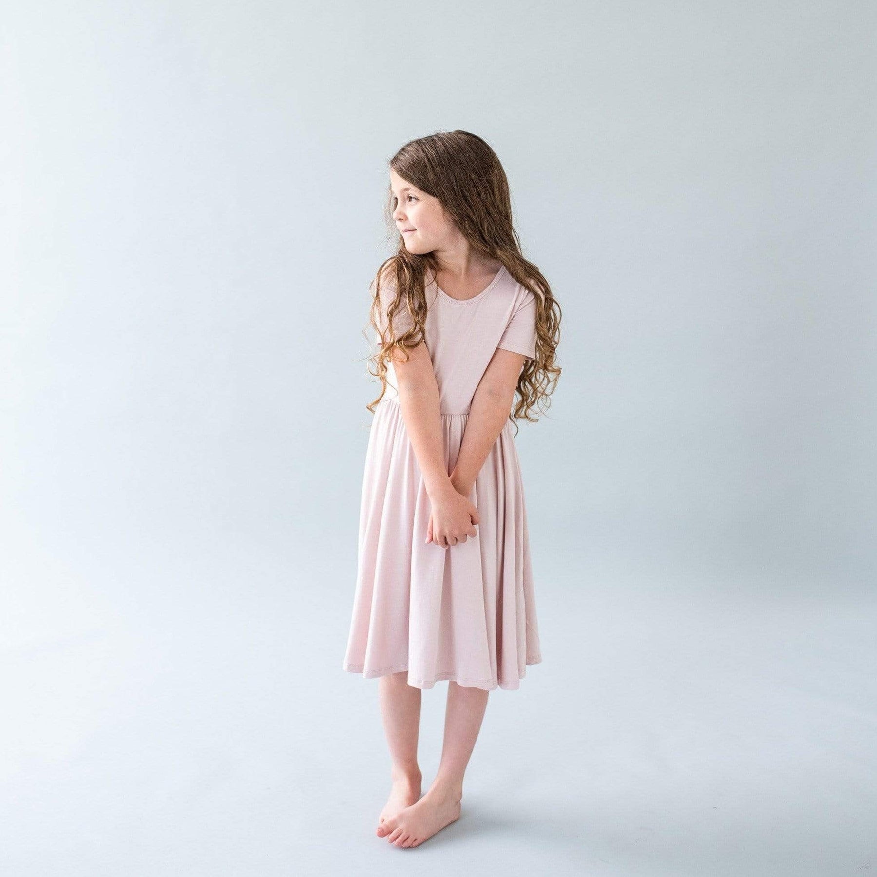 Toddler wearing a blush twirl dress