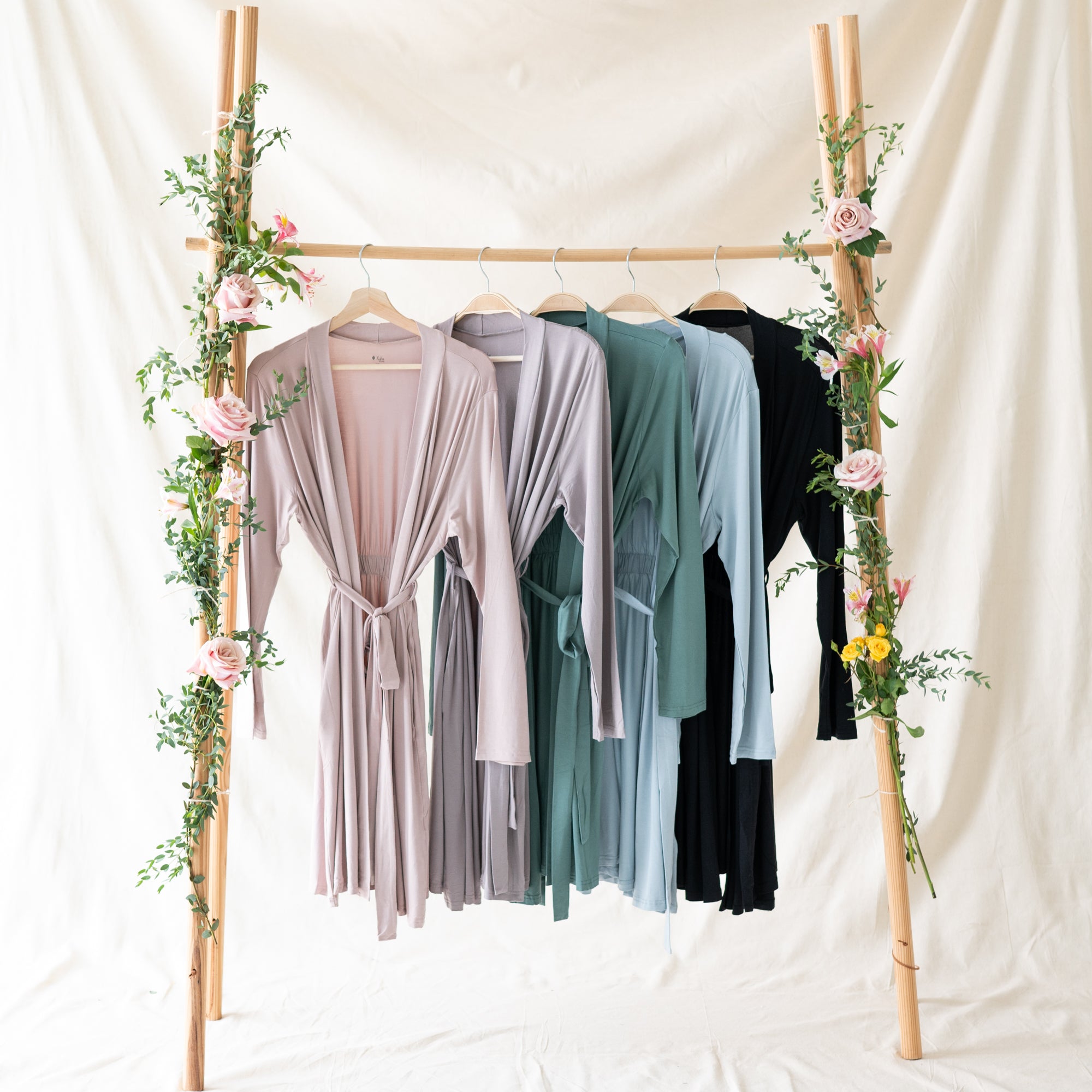 Three Women standing together modeling the jogger sets in pine, mulberry and charcoal