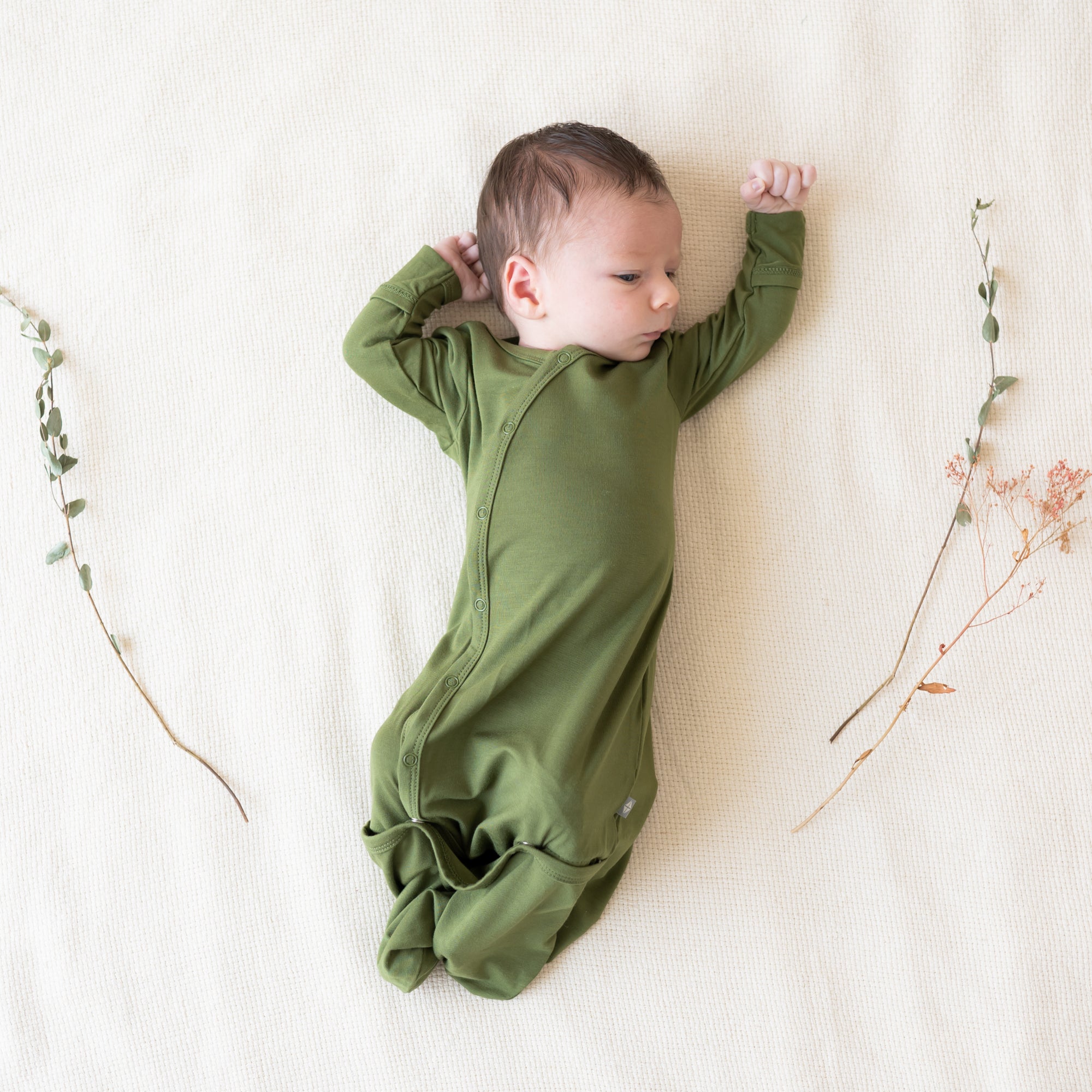 Baby wearing a Bundler in Olive