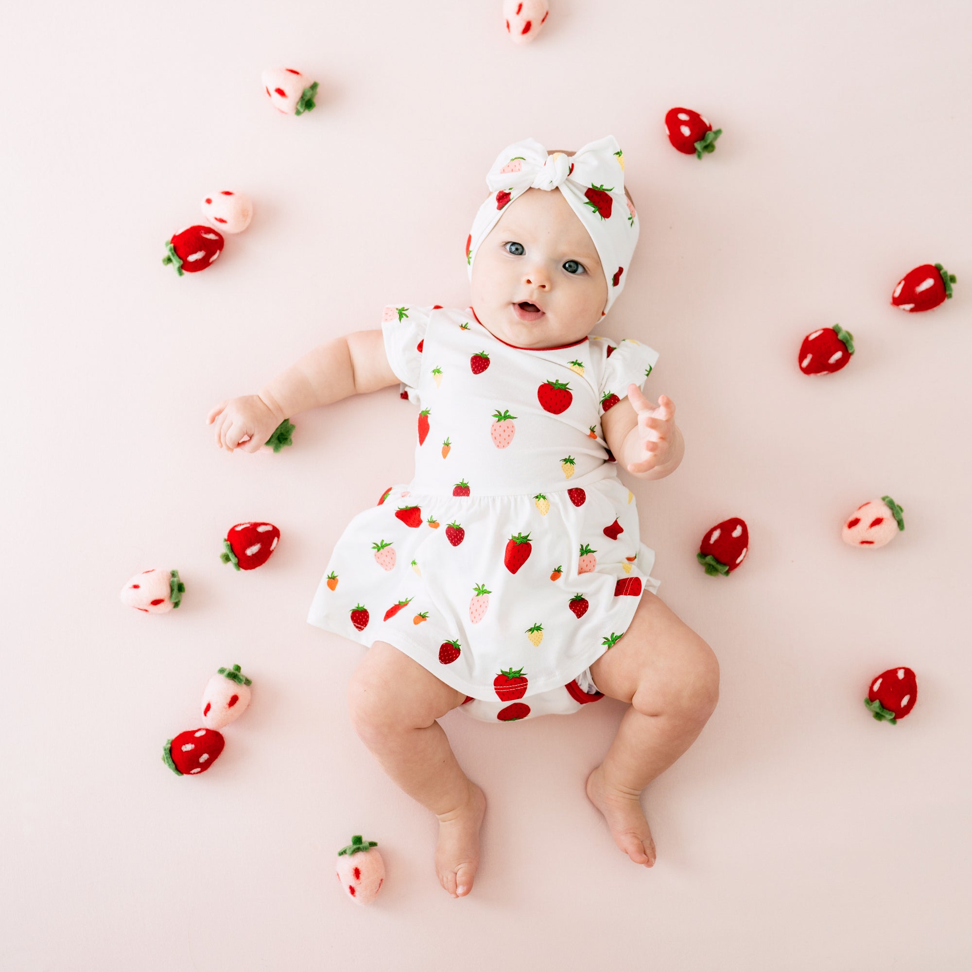 Baby wearing Twirl Bodysuit Dress in Strawberry