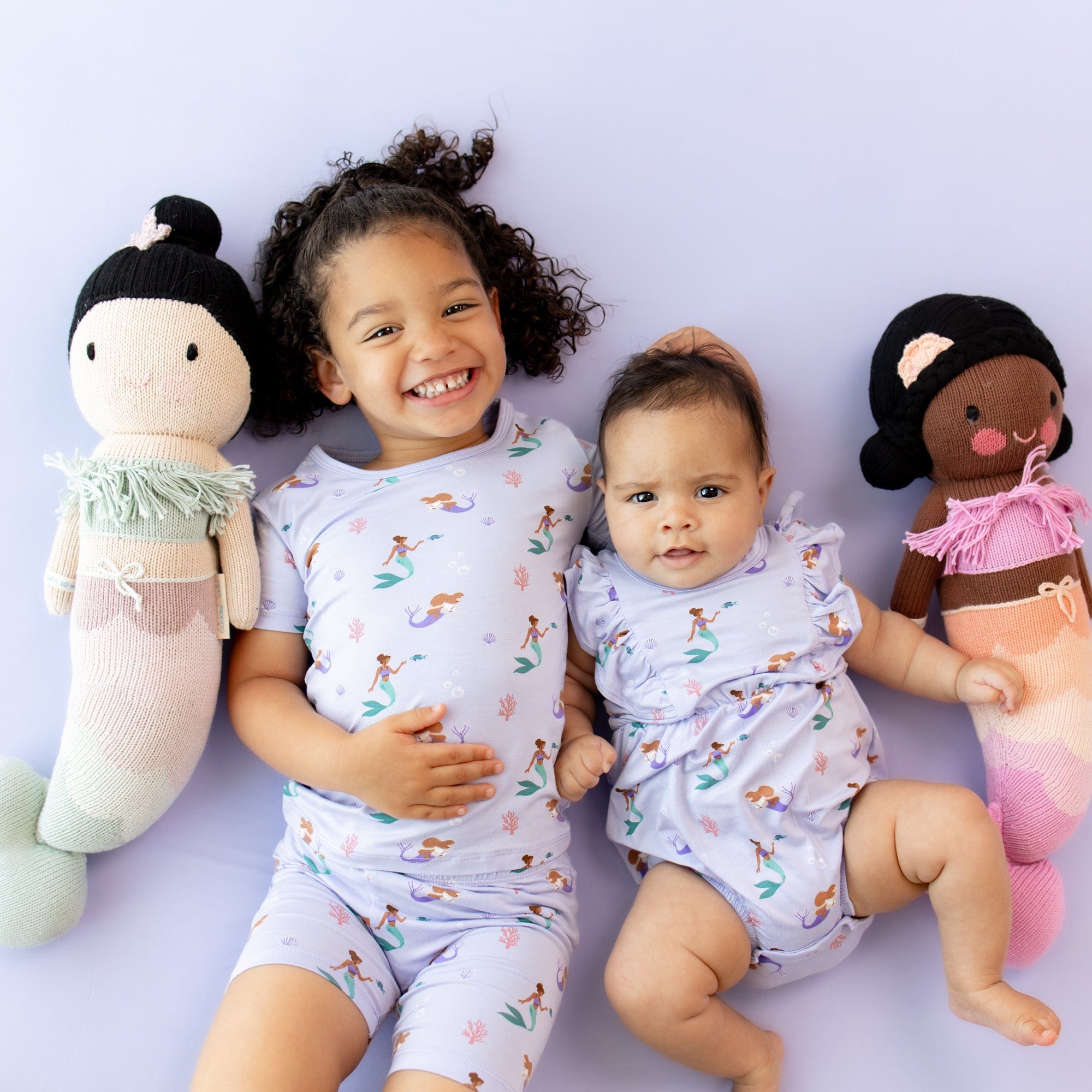 Siblings wearing Kyte Baby matching kids outfits in Mermaid