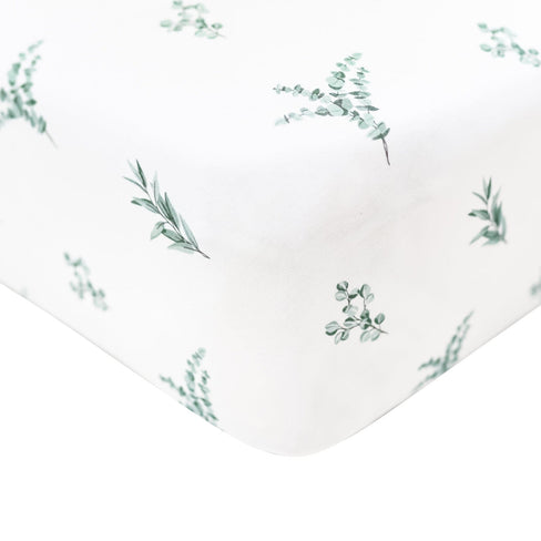 Crib sheet in the print eucalyptus shown on a mattress