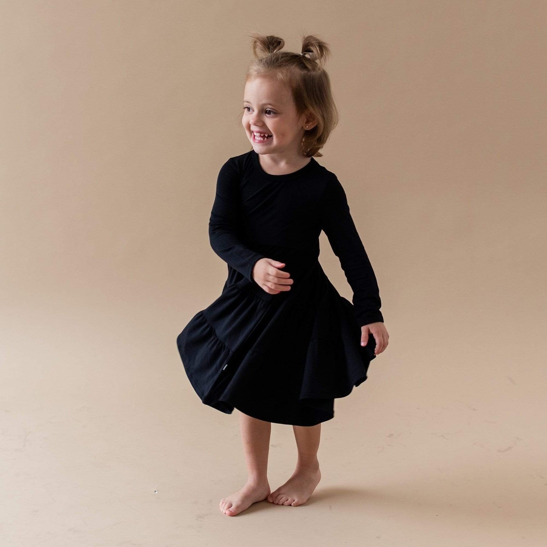 toddler modeling tiered dress in midnight