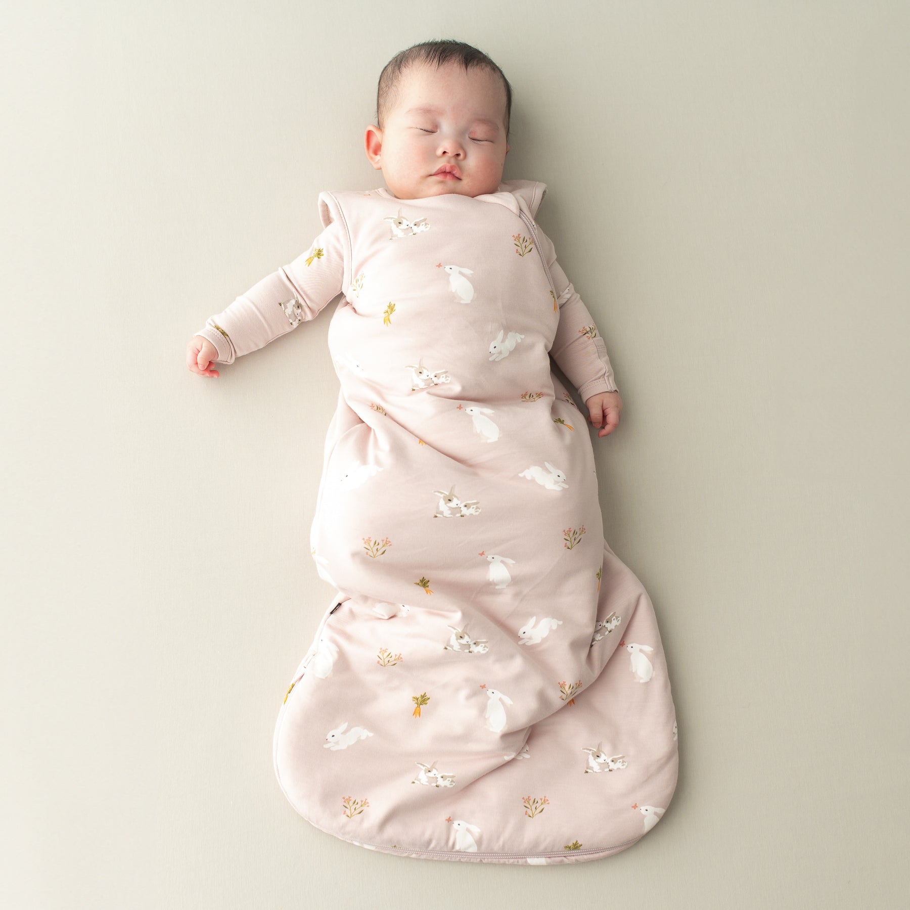 Baby sleeping in Sleep Bag in Blush Rabbit 1.0