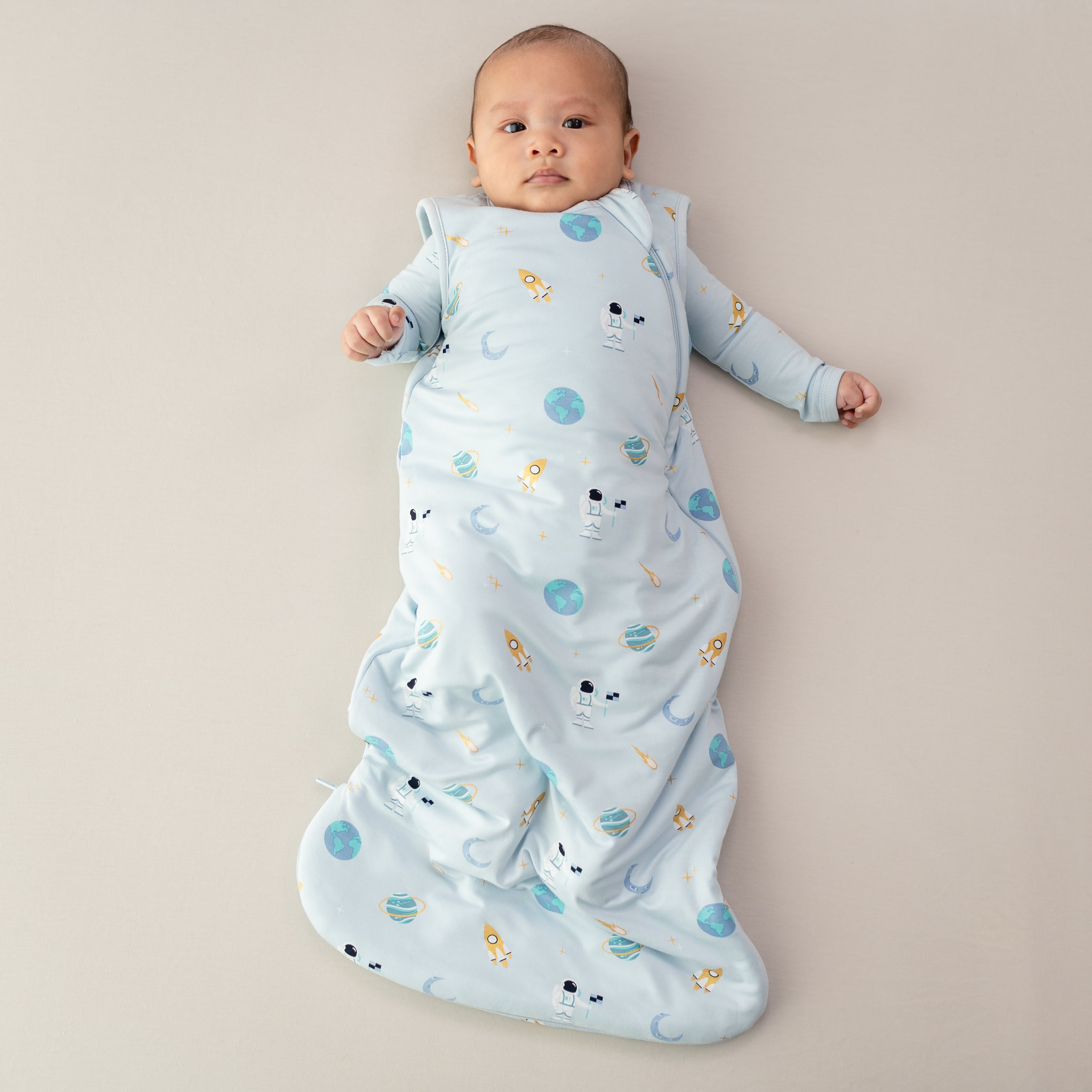 baby laying down wearing 1.0 tog sleep bag in ice space