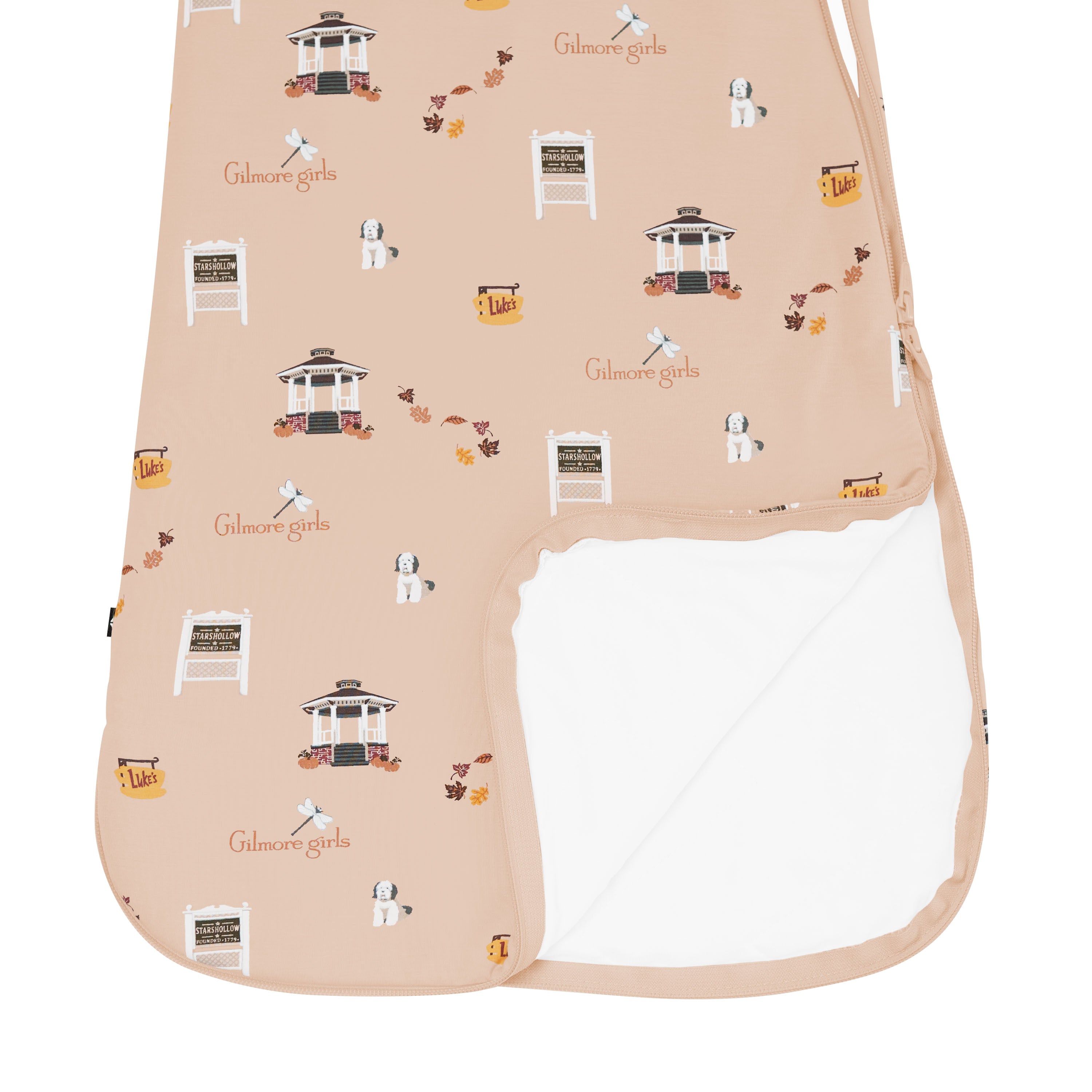 Beige sleep bag with 'Gilmore Girls' themed pattern on a white background