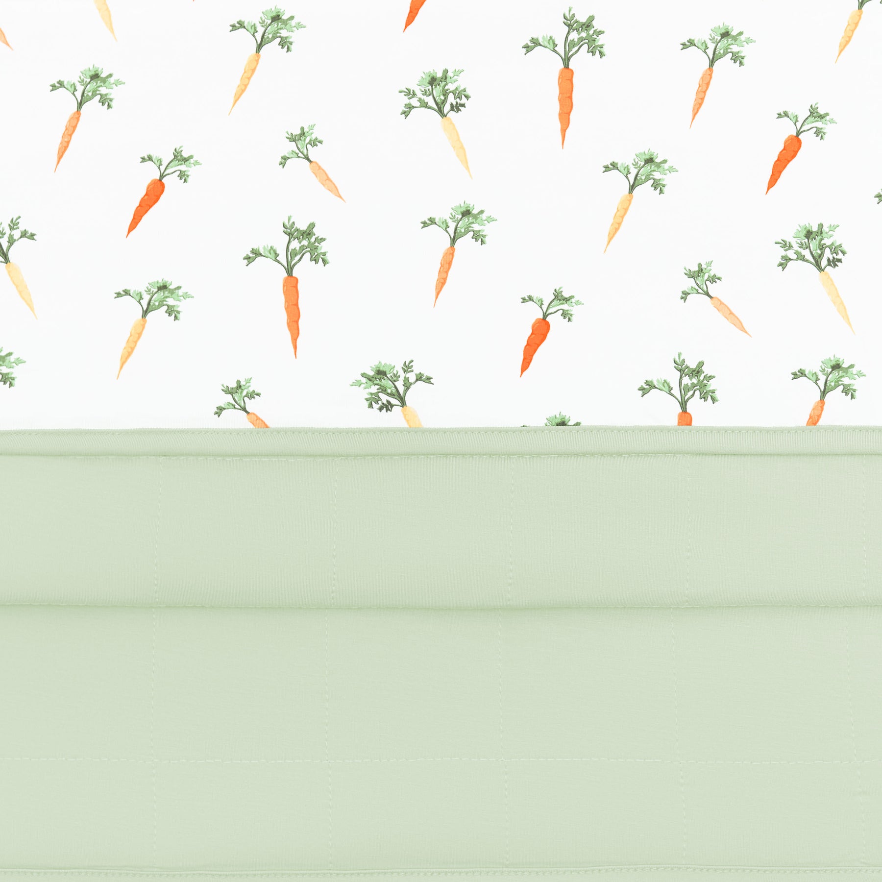 Close up of the quilted backing and smooth top of the Baby Blanket in Carrot