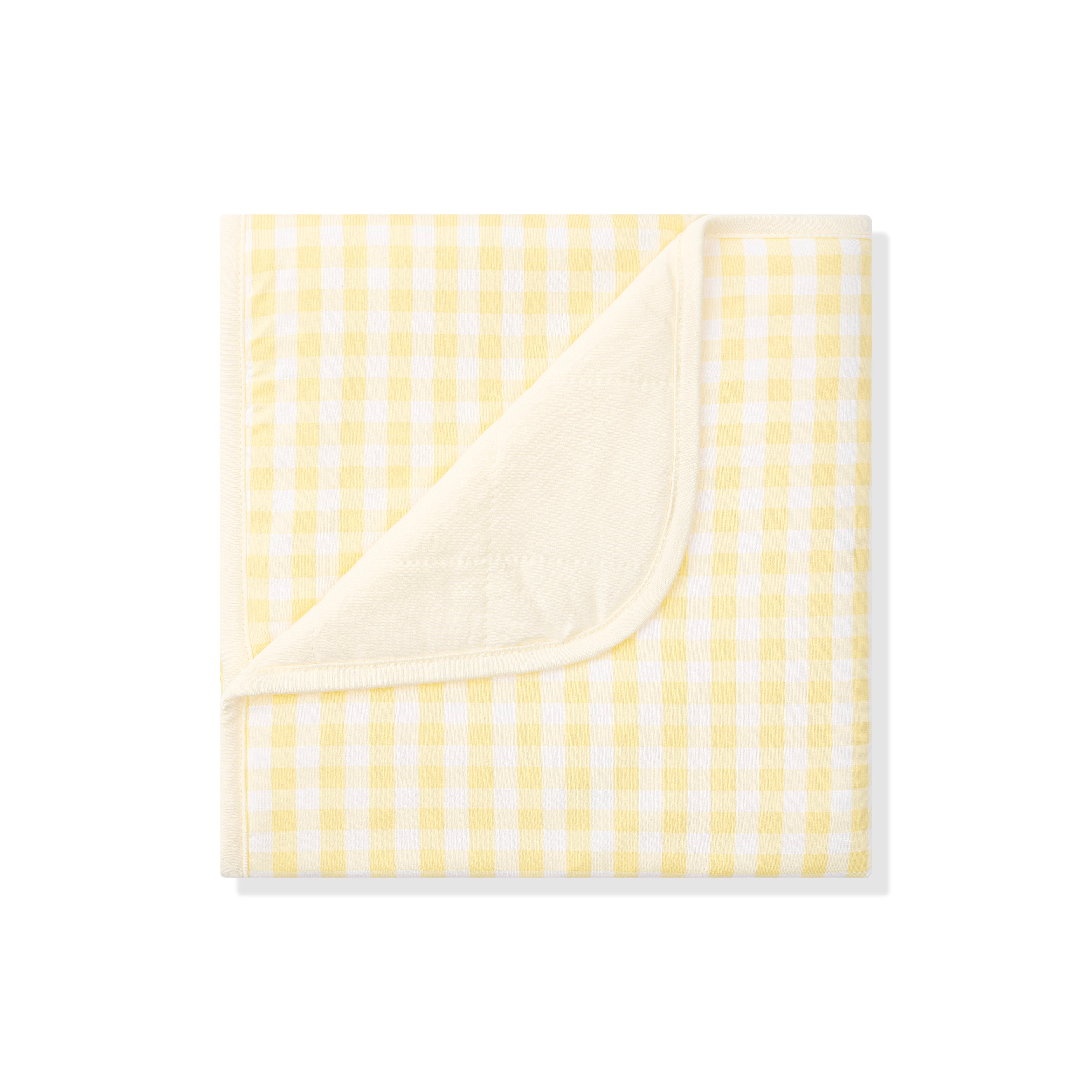 Baby Blanket in Gingham Chamomile with the corner flipped down showing the light yellow backing