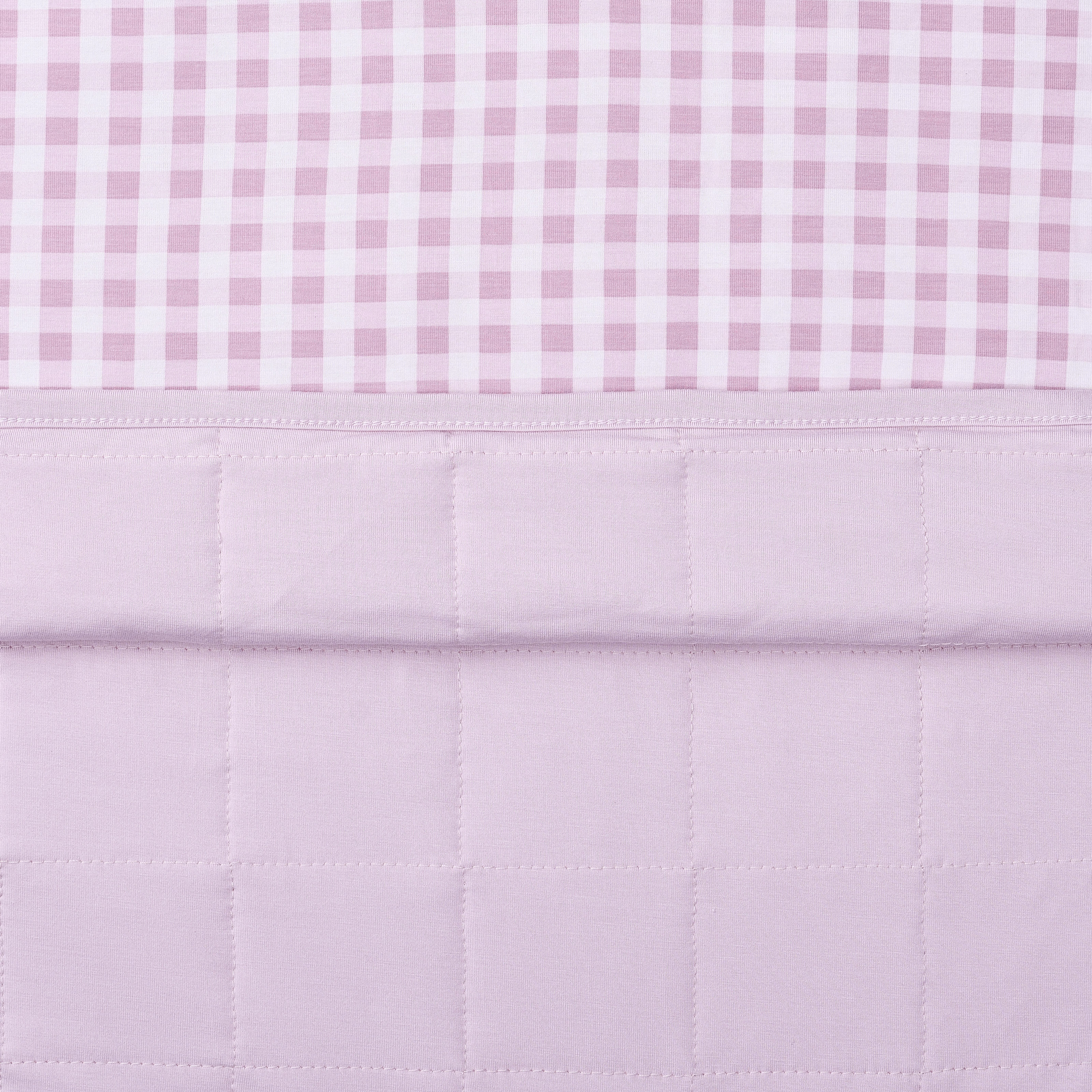 Close up of the quilted light purple backing and the smooth patterned top layer of the Baby Blanket in Gingham Thistle