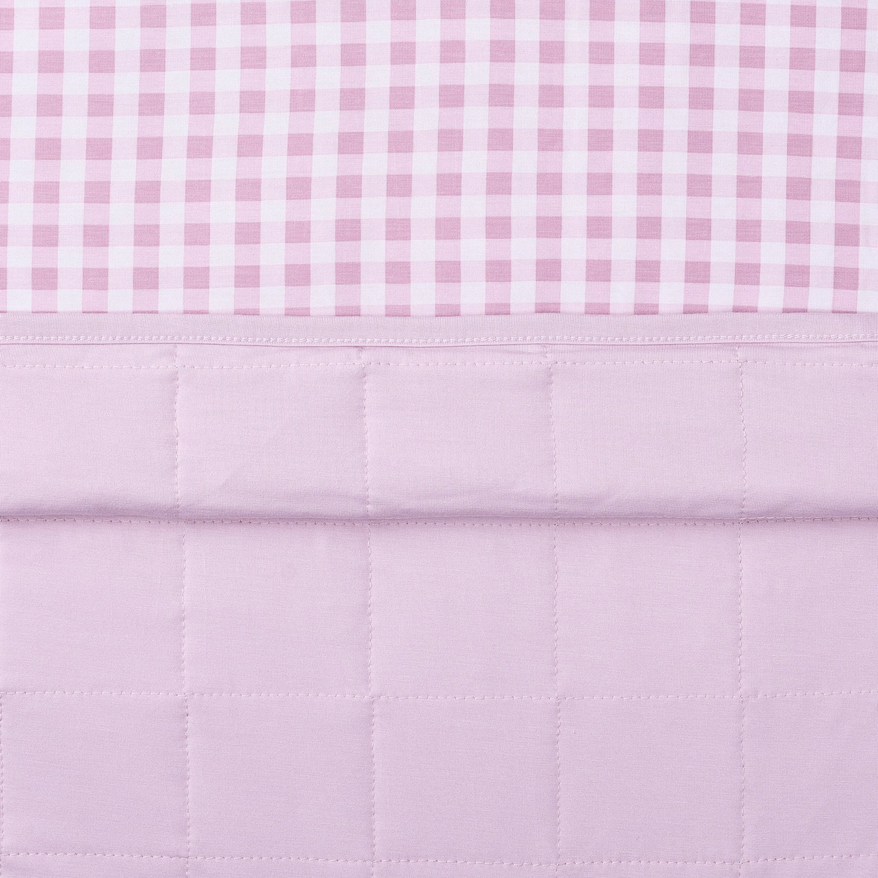 Close up of the quilted light purple backing and the smooth patterned top layer of the Baby Blanket in Gingham Thistle