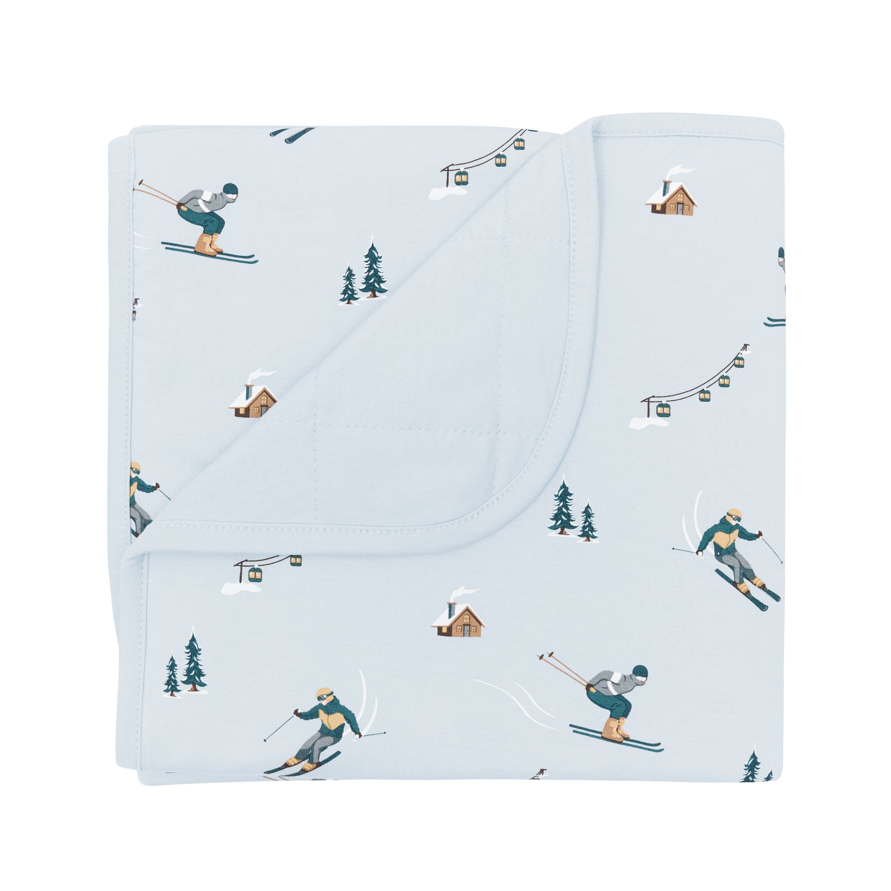 Baby Blanket in Ski with the corner flipped down showing the light blue backing resting on a white surface