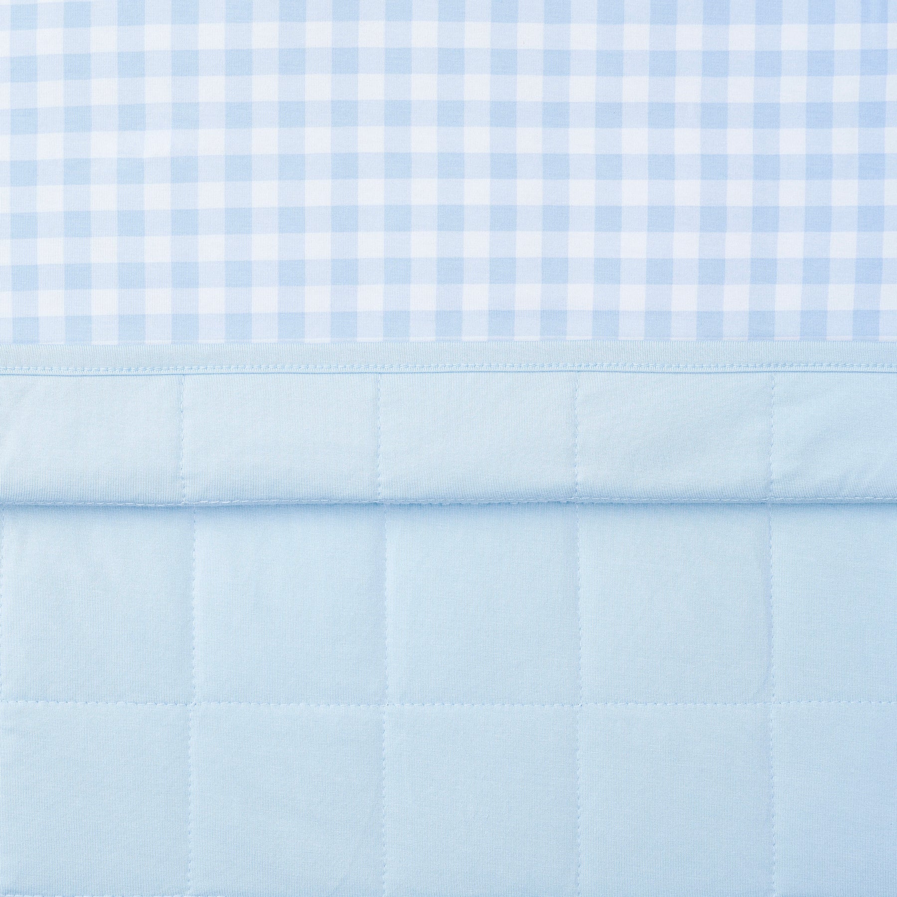 Close up of the quilted backing and smooth top patterned layer of the Toddler Blanket in Gingham Breeze 1.0