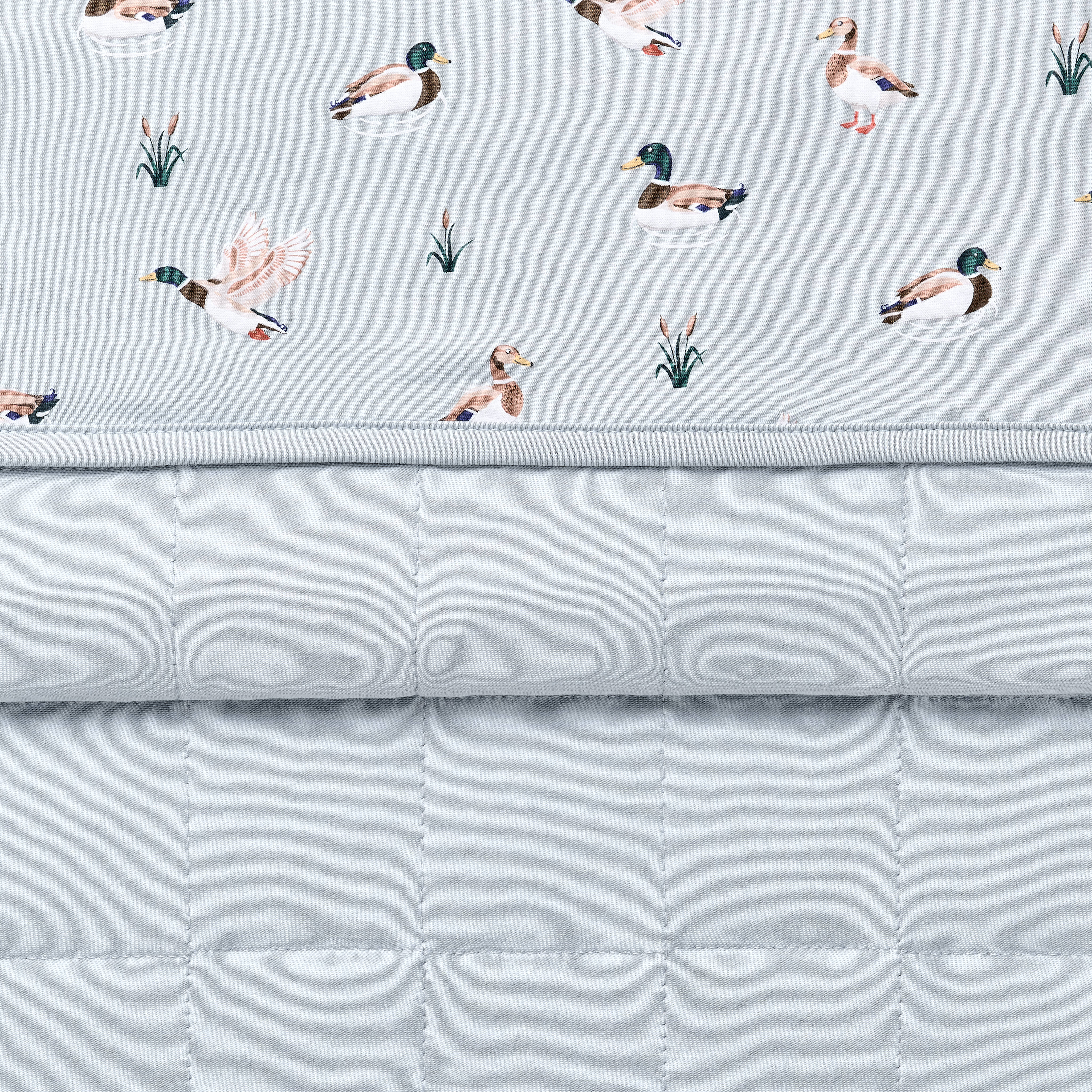 Close up of the Toddler Blanket in Mallard Duck 1.0 showing the light blue quilted backing and patterned smooth to player