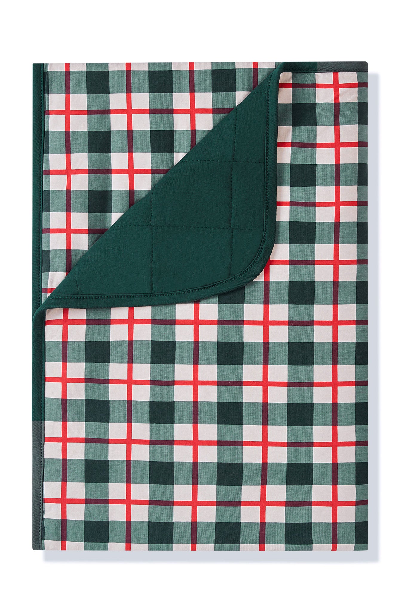 A folded plaid blanket with a green, white, and red checkered pattern, showing a solid dark green reverse side, photographed on a clean white background.