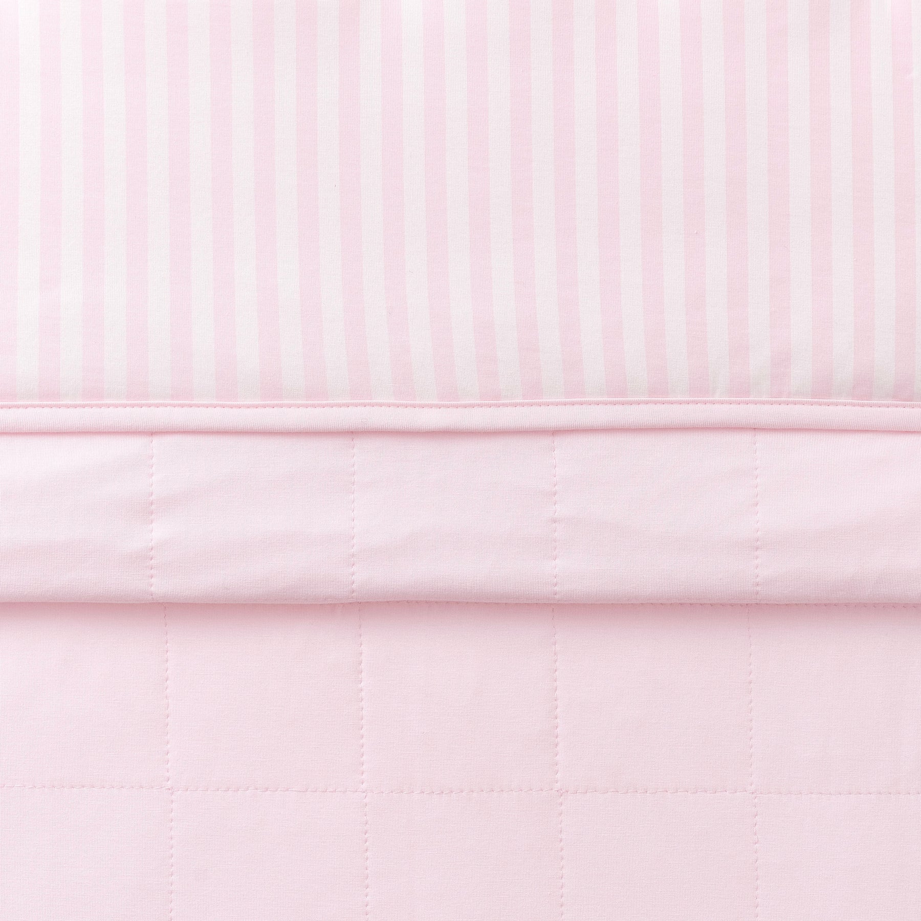 Toddler Blanket in Small Sakura Stripe 1.0 folded showing the quilted detail on the back of the blanket and the print detail on the front