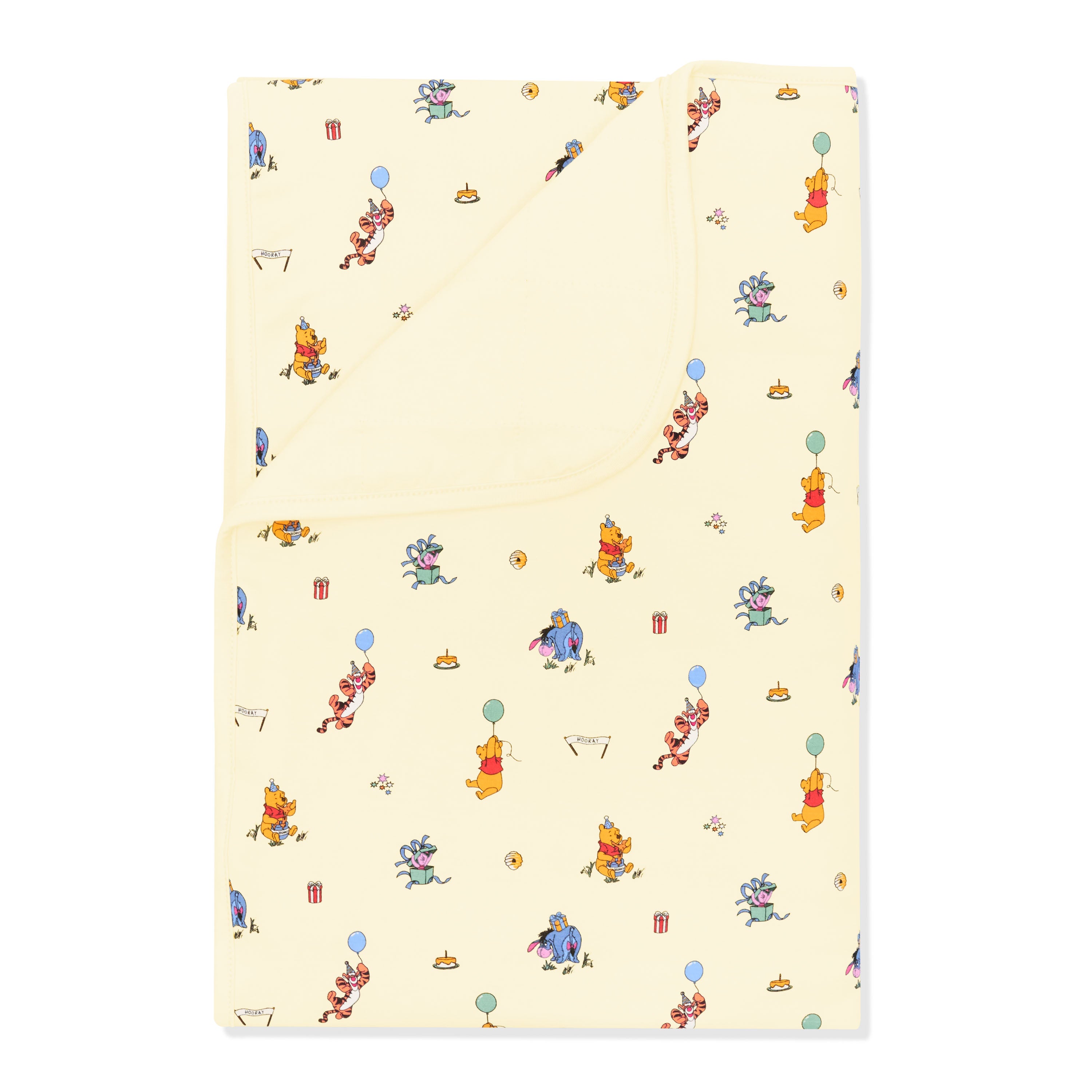 Toddler Blanket in Winnie the Pooh Celebration 1.0 with the corner folded down showing the light yellow backing