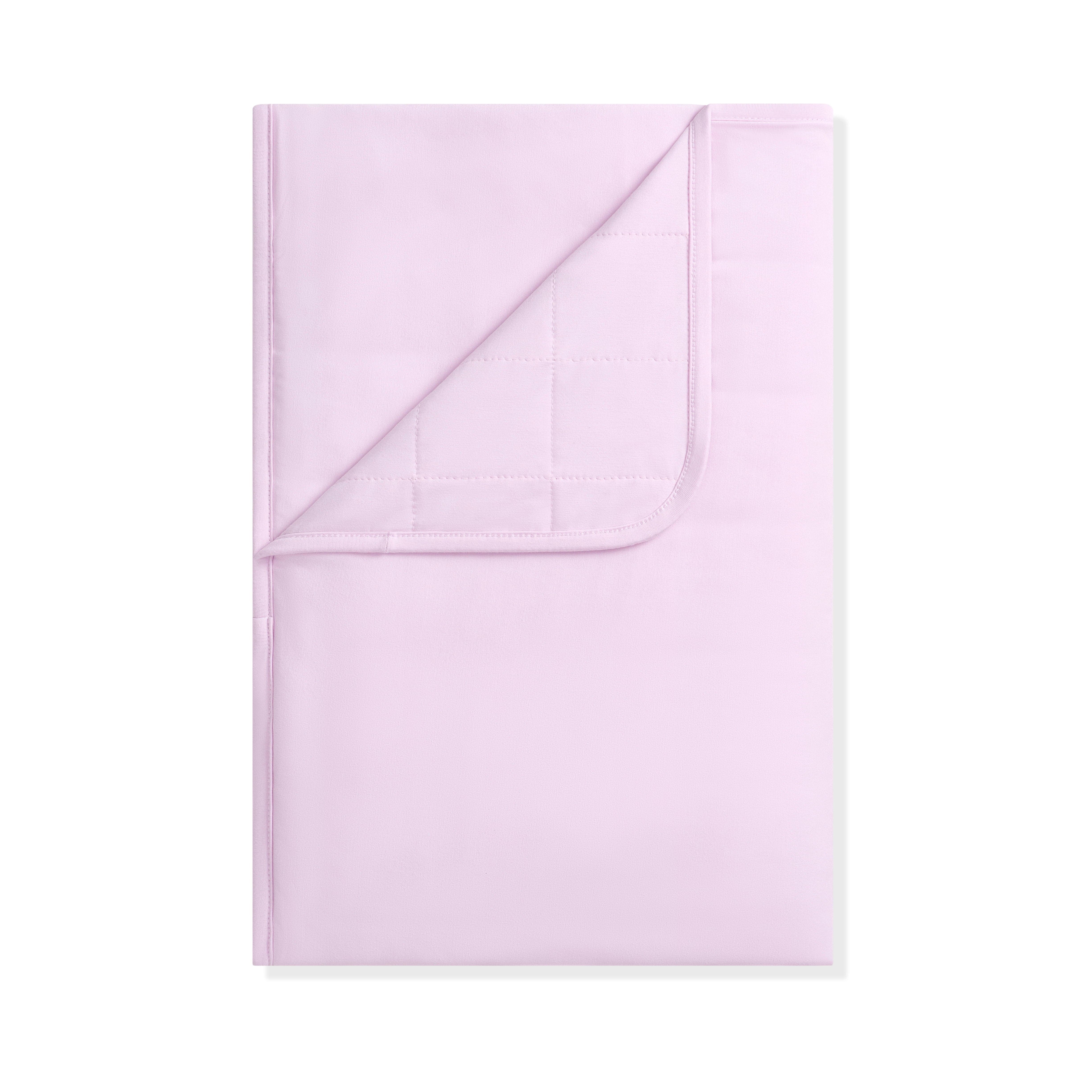 Folded light purple blanket on a white background