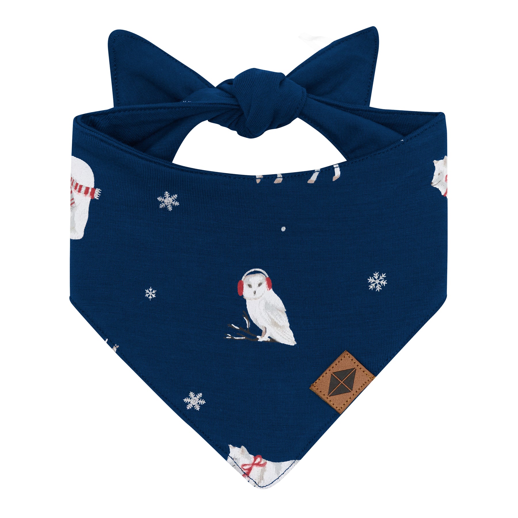 The front of the Dog Bandana in Frosty Friends showing the Vegan leather Kyte Baby tag