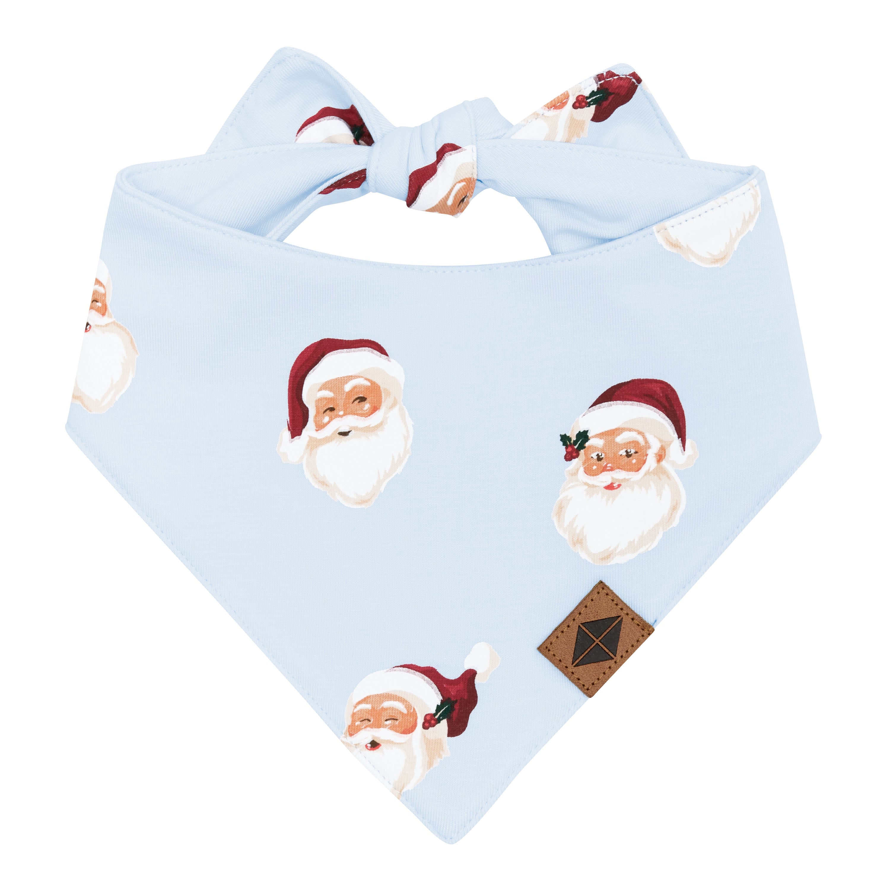 The front of the Dog Bandana in Vintage Santa showing the Vegan Leather Kyte Baby logo tag with the tie closure visible