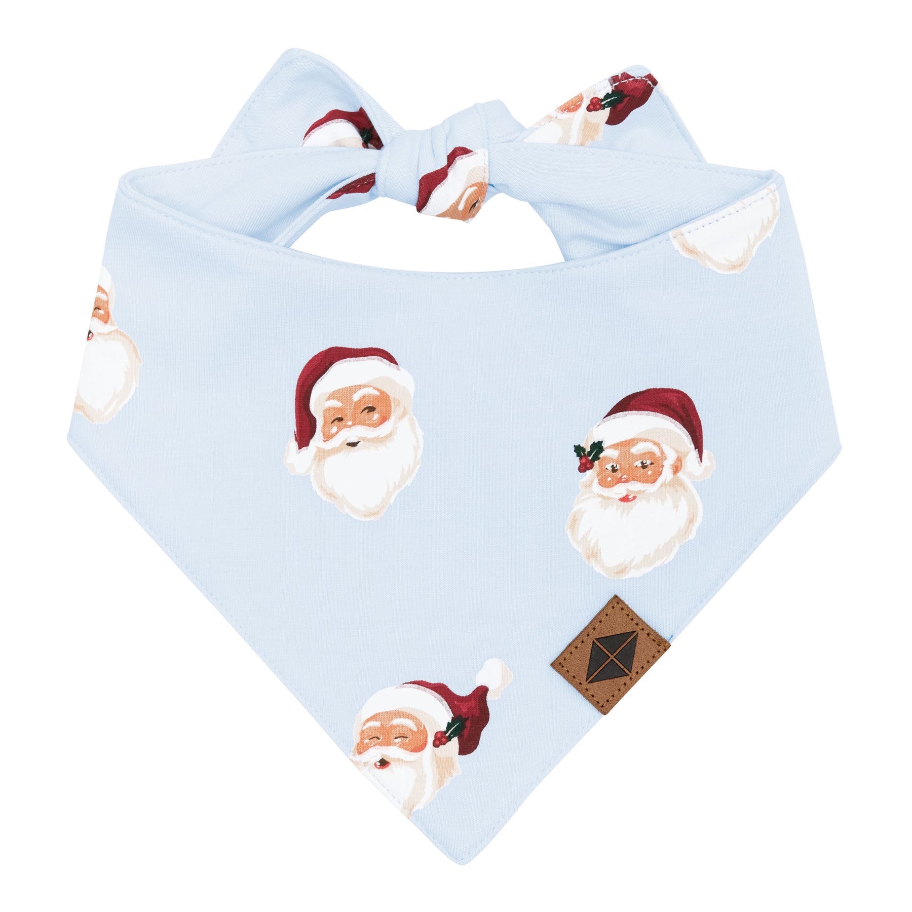 The front of the Dog Bandana in Vintage Santa showing the Vegan Leather Kyte Baby logo tag with the tie closure visible