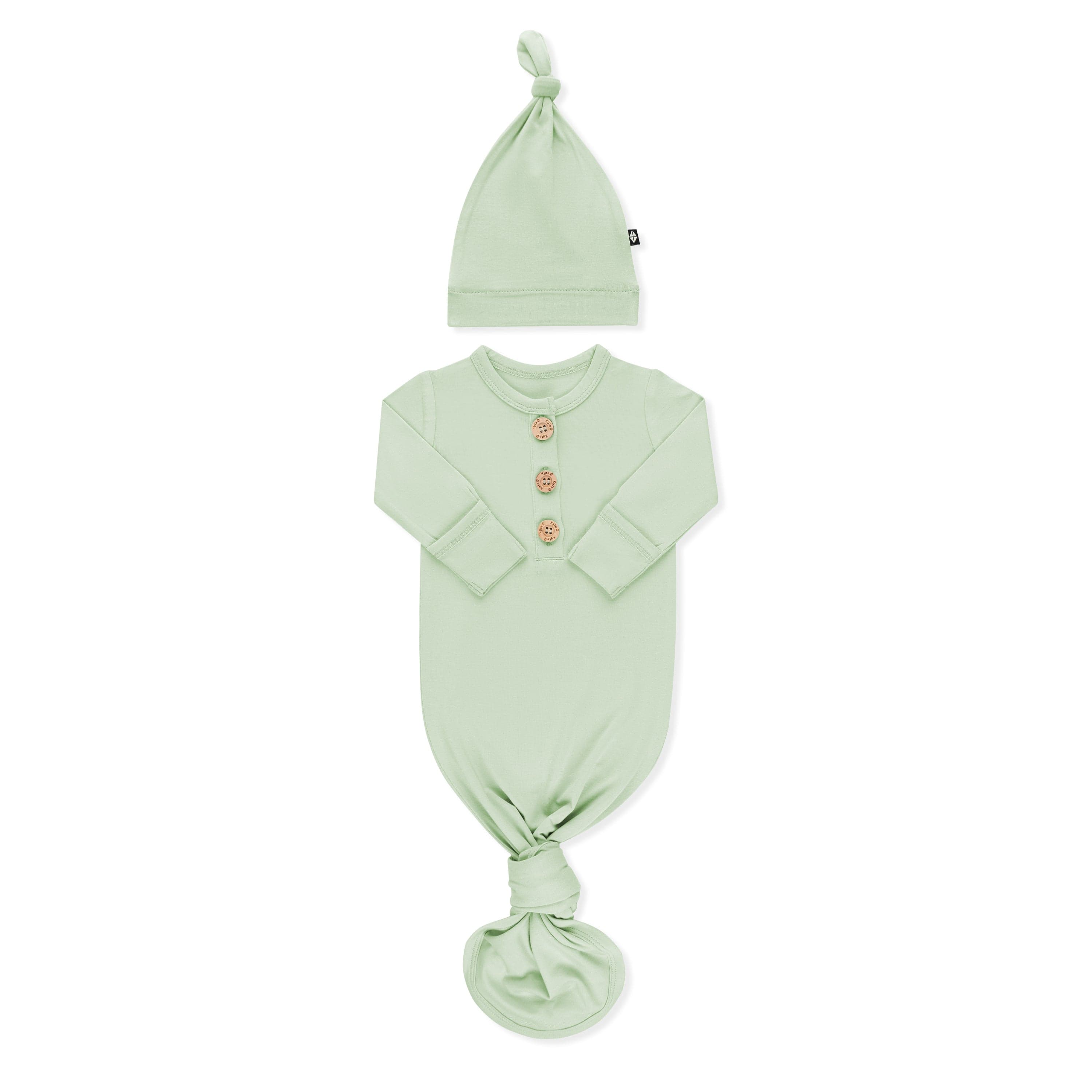 Product photo of the Knotted Gown with Hat Set in Basil with the arms folded inwards