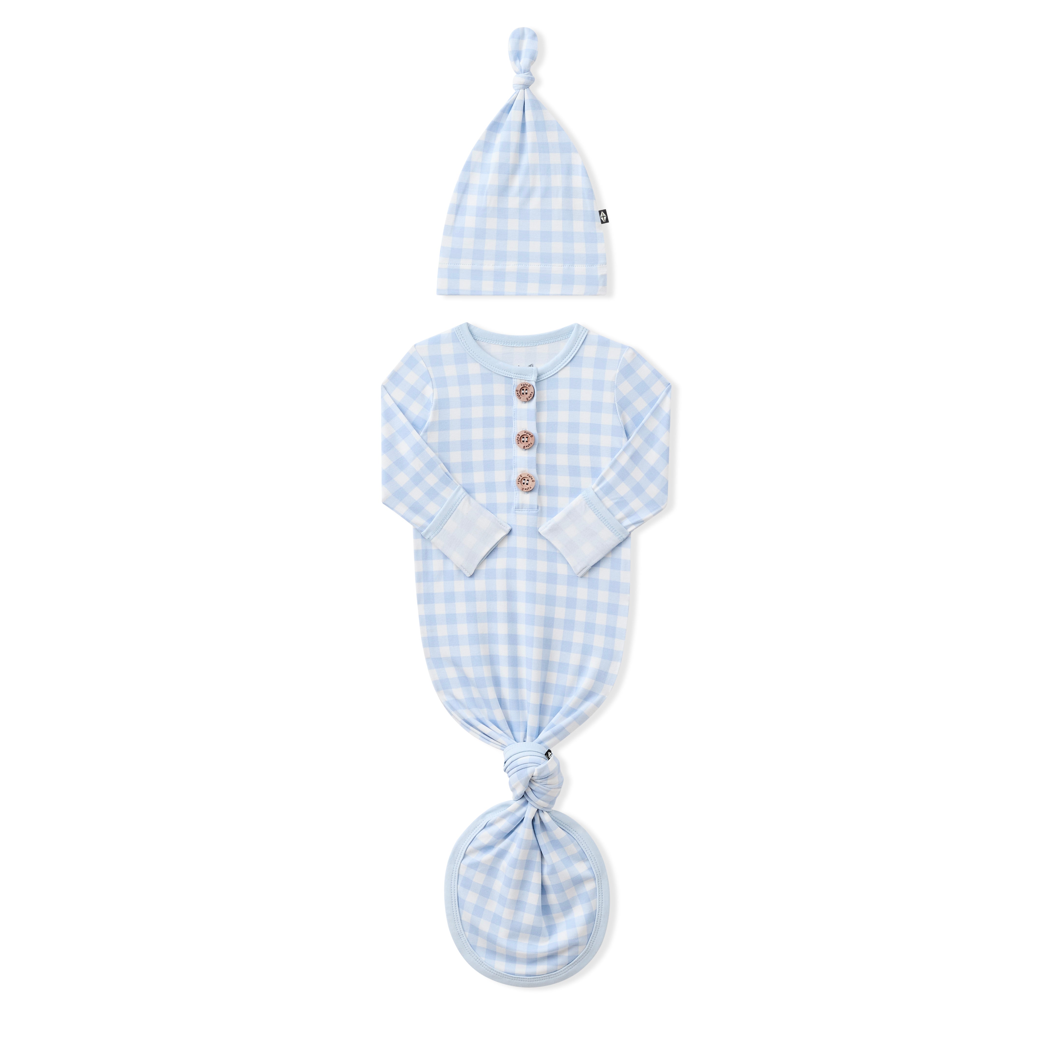 Knotted Gown with Hat Set in Gingham Breeze with the arms folded inwards showing the fold over hand cuffs