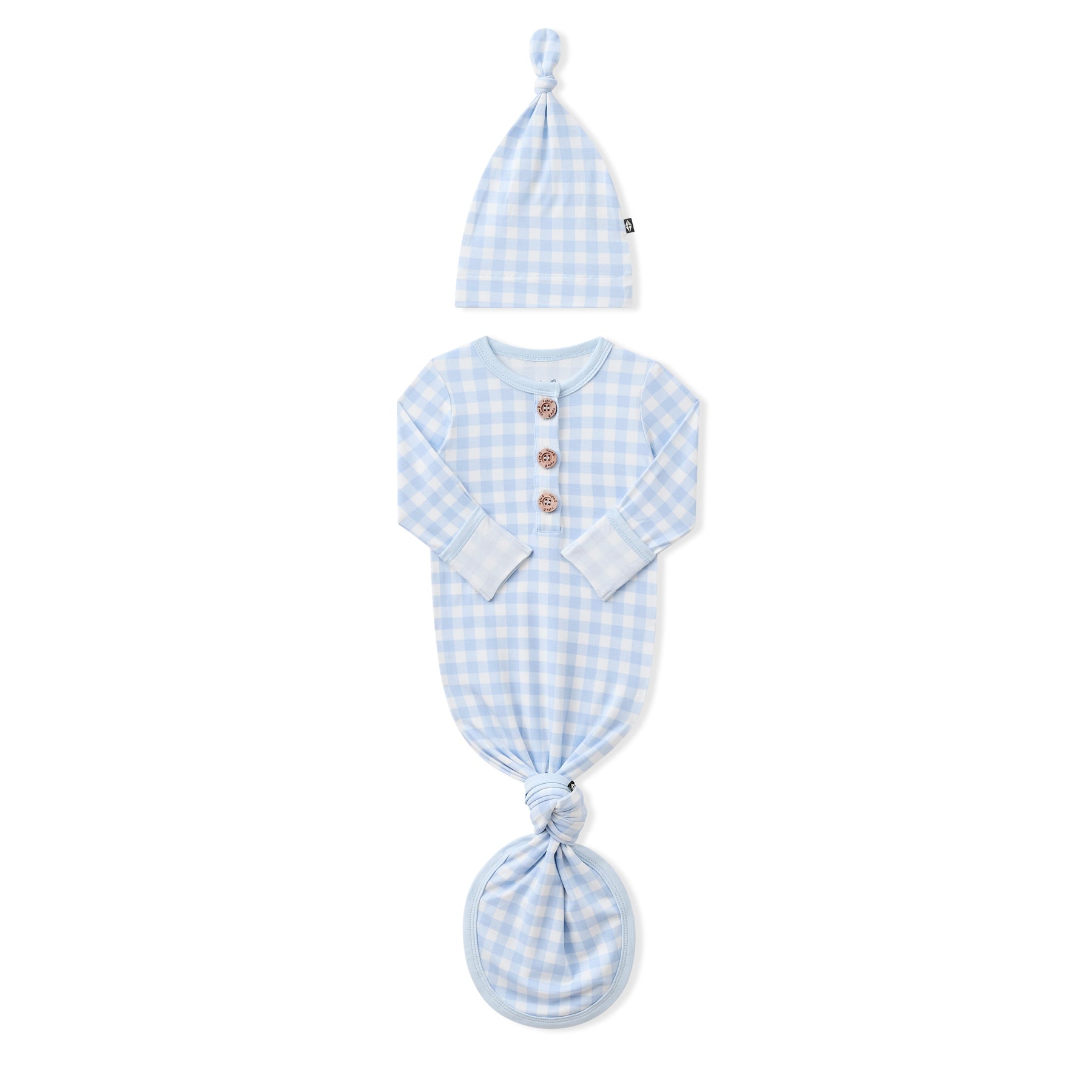 Knotted Gown with Hat Set in Gingham Breeze with the arms folded inwards showing the fold over hand cuffs