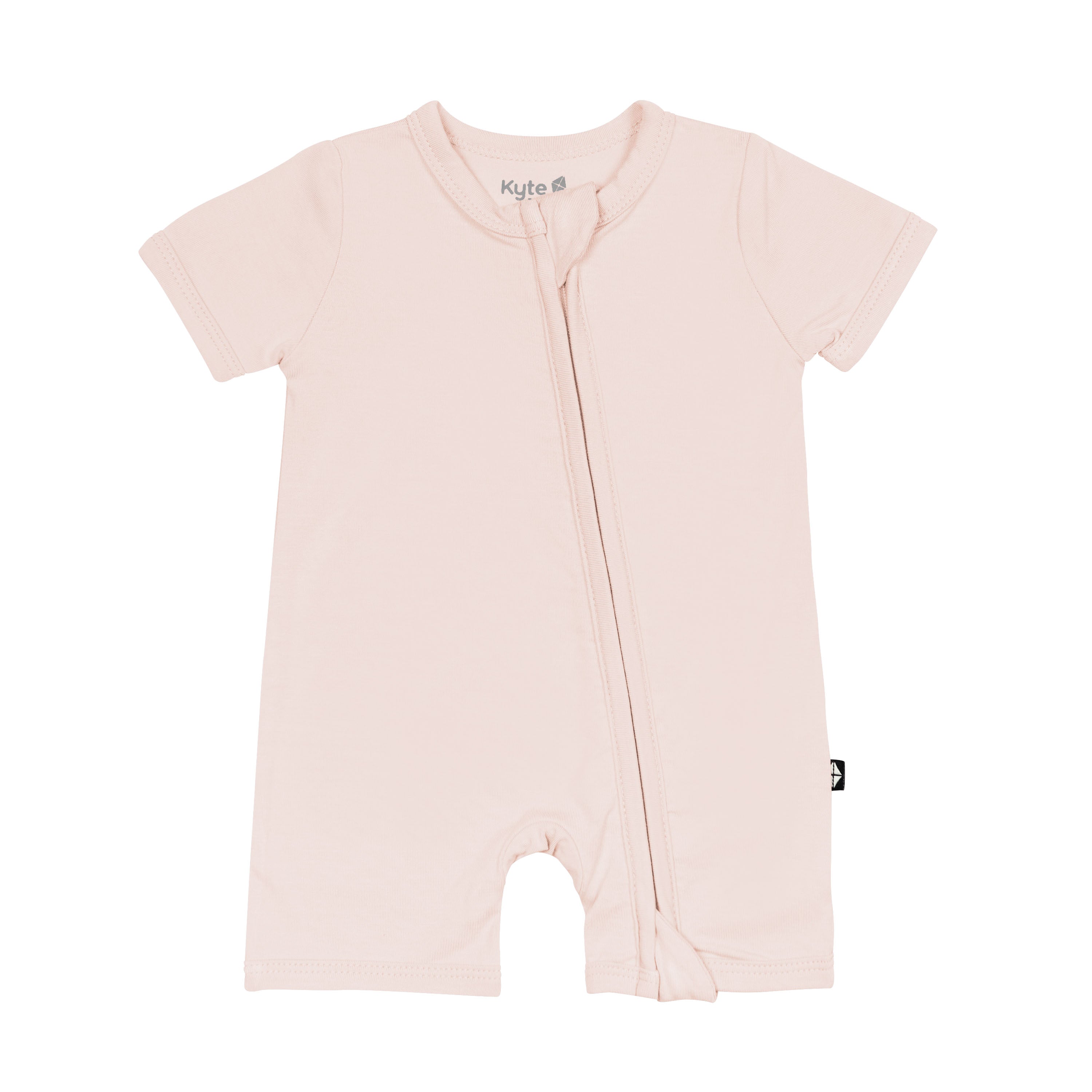 Flat lay of Kyte Baby Zipper Shortall Romper in Blush