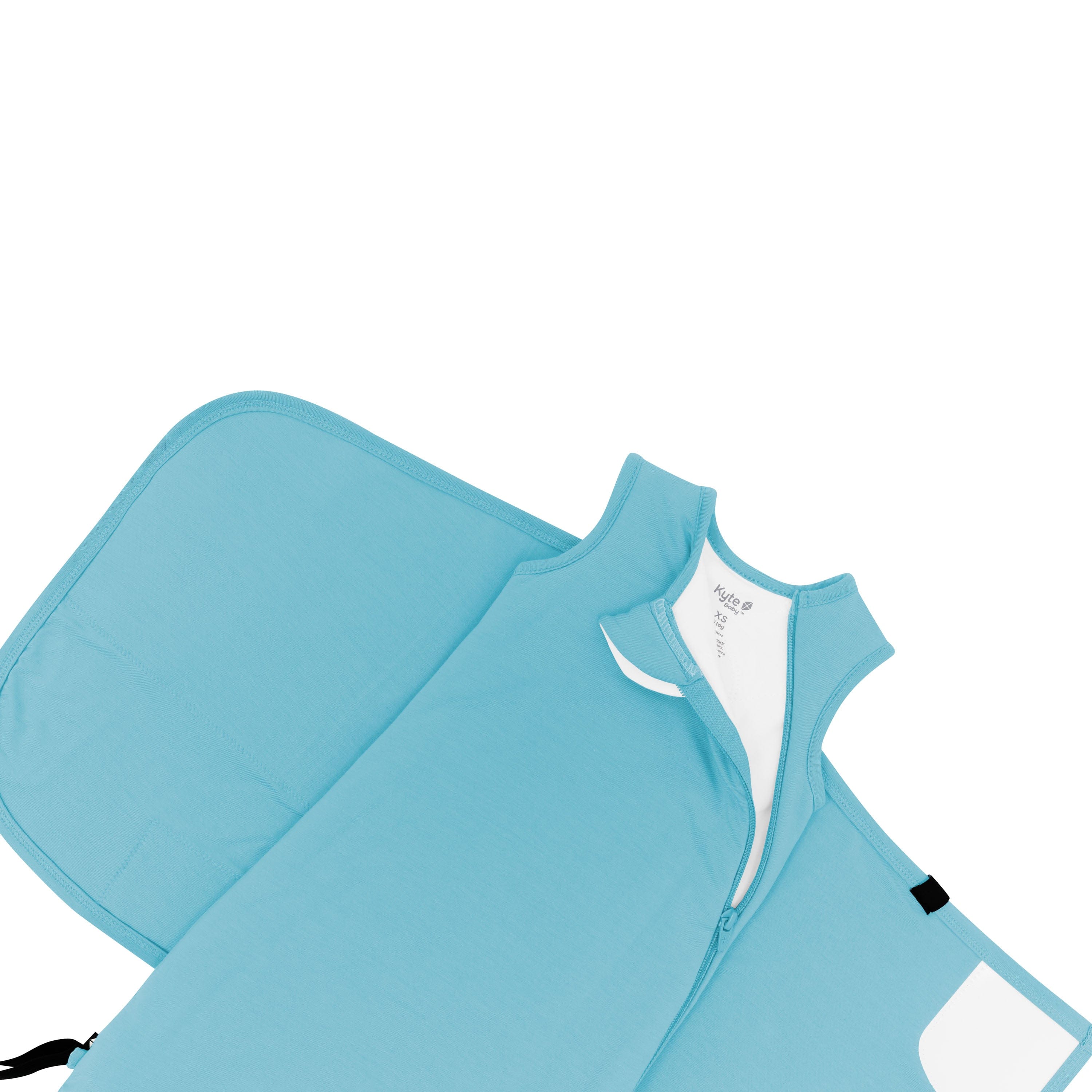 Kyte Baby Sleep Bag Swaddler in Makai shown top unzipped