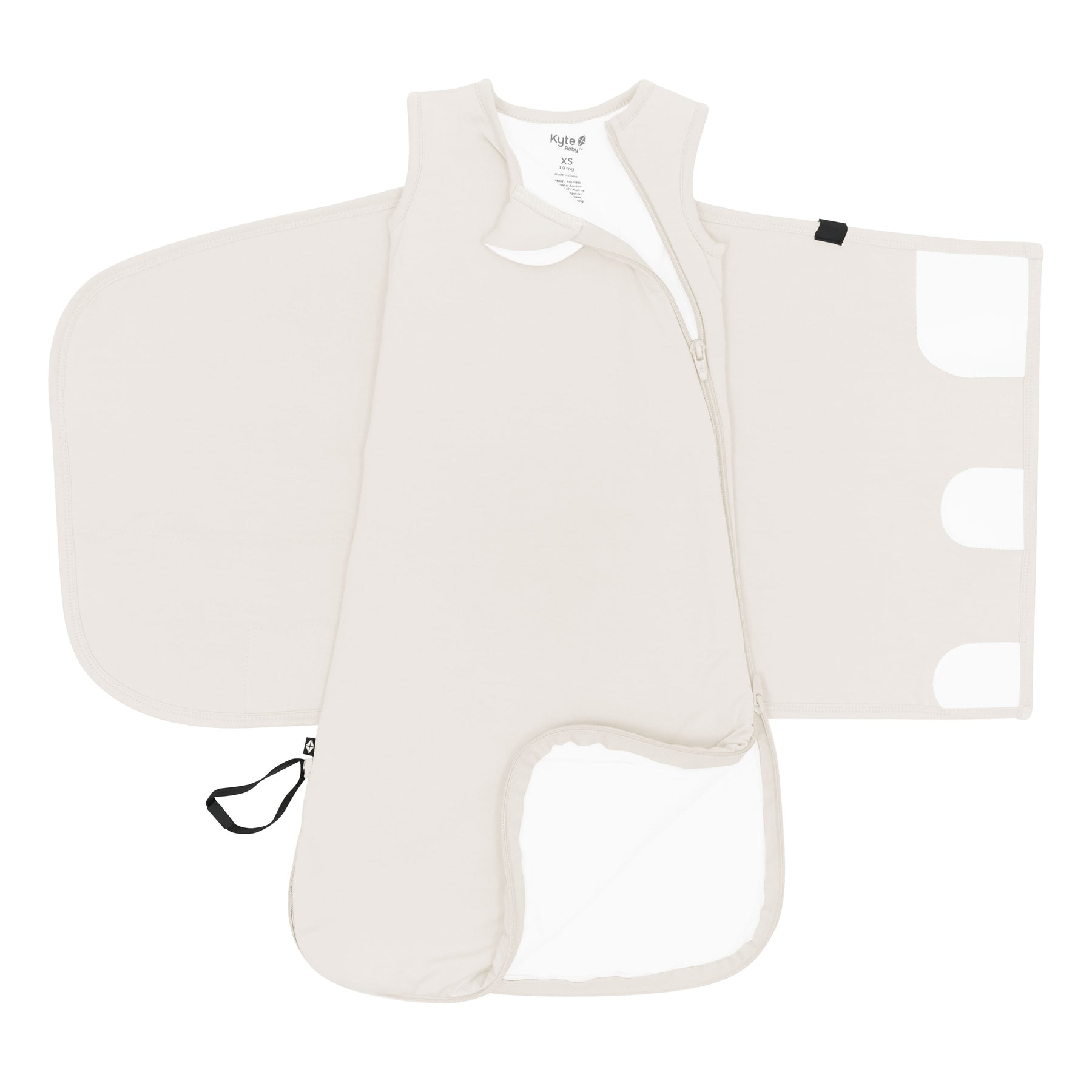 Zipper garage, double zipper and adjustable velcro shown on an unswaddled Sleep Bag Swaddler in Oat 1.0