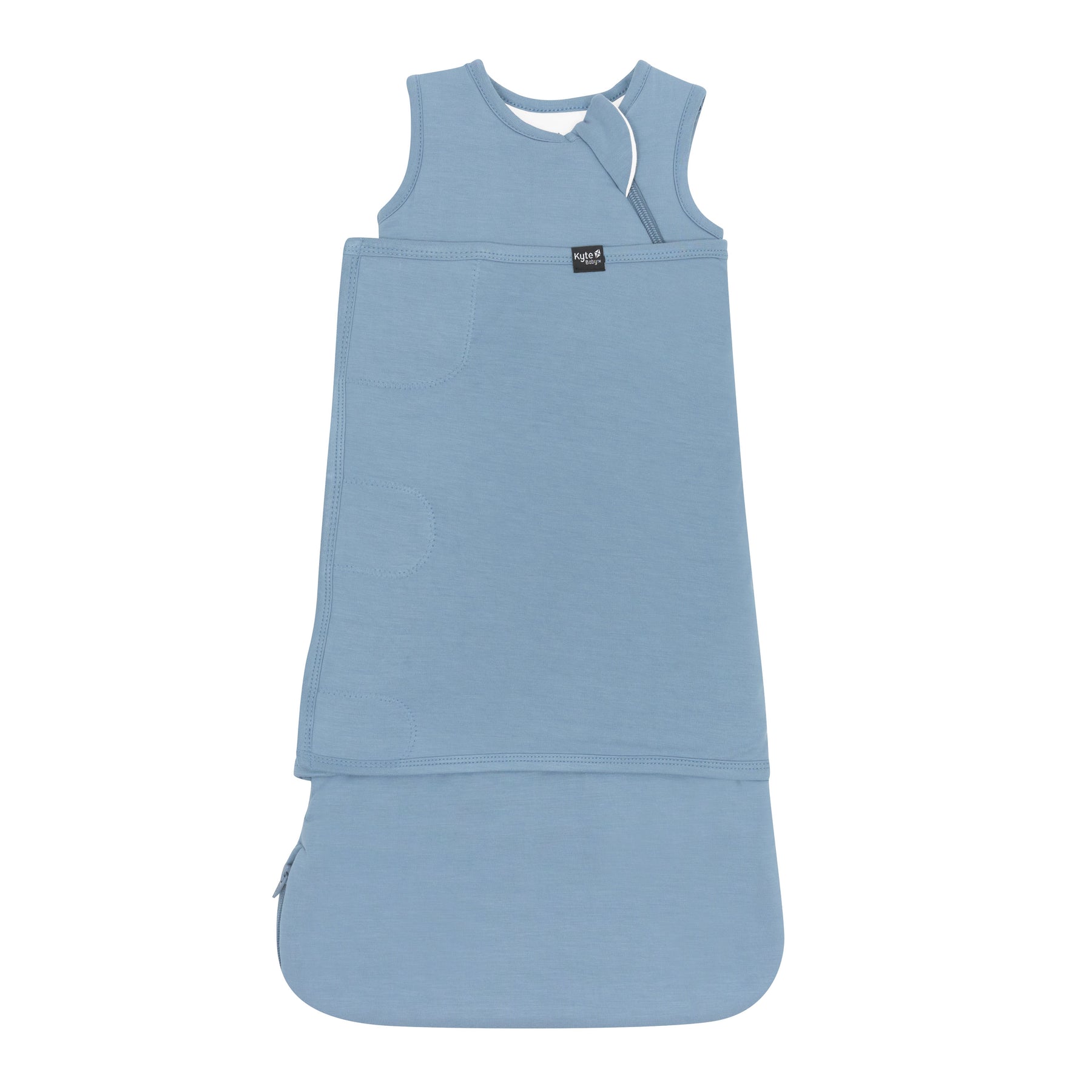 Sleep Bag Swaddler in Slate 1.0 shown swaddled with the Black Kyte Baby logo tag visible