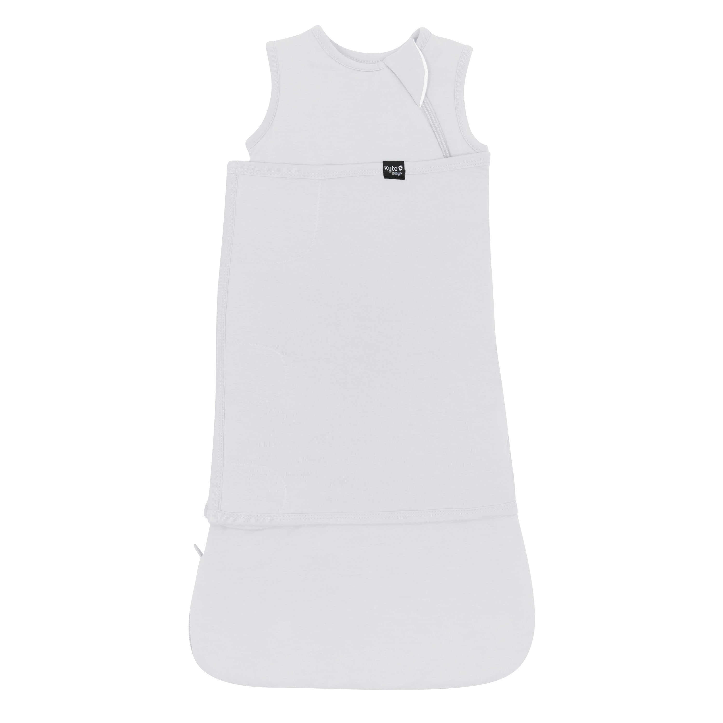 Sleep Bag Swaddler in Storm 1.0 shown swaddled with the black kyte baby logo tag visible