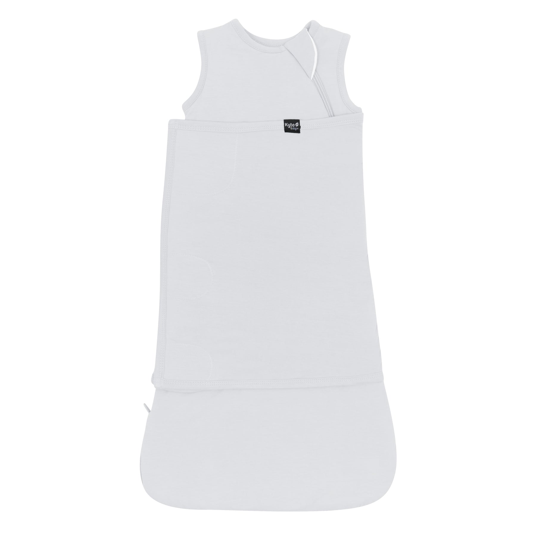 Sleep Bag Swaddler in Storm 1.0 shown swaddled with the black kyte baby logo tag visible