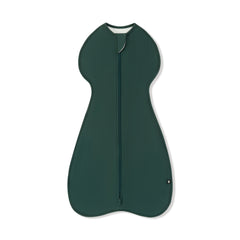 A dark green zippered baby swaddle with a rounded, ergonomic shape, shown flat against a white background.