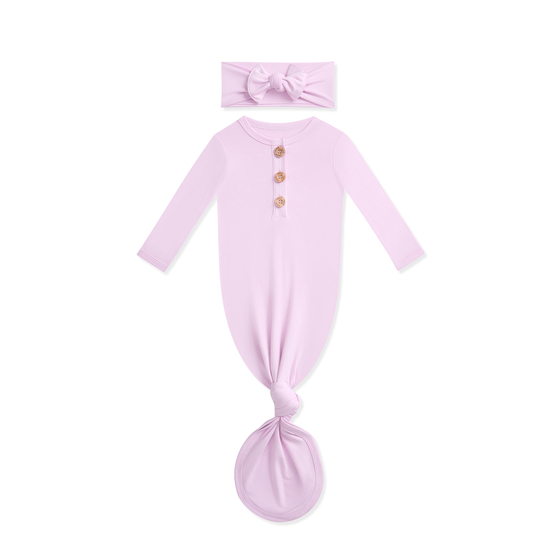 Lavender baby knotted gown with wooden buttons and matching headband on a white background
