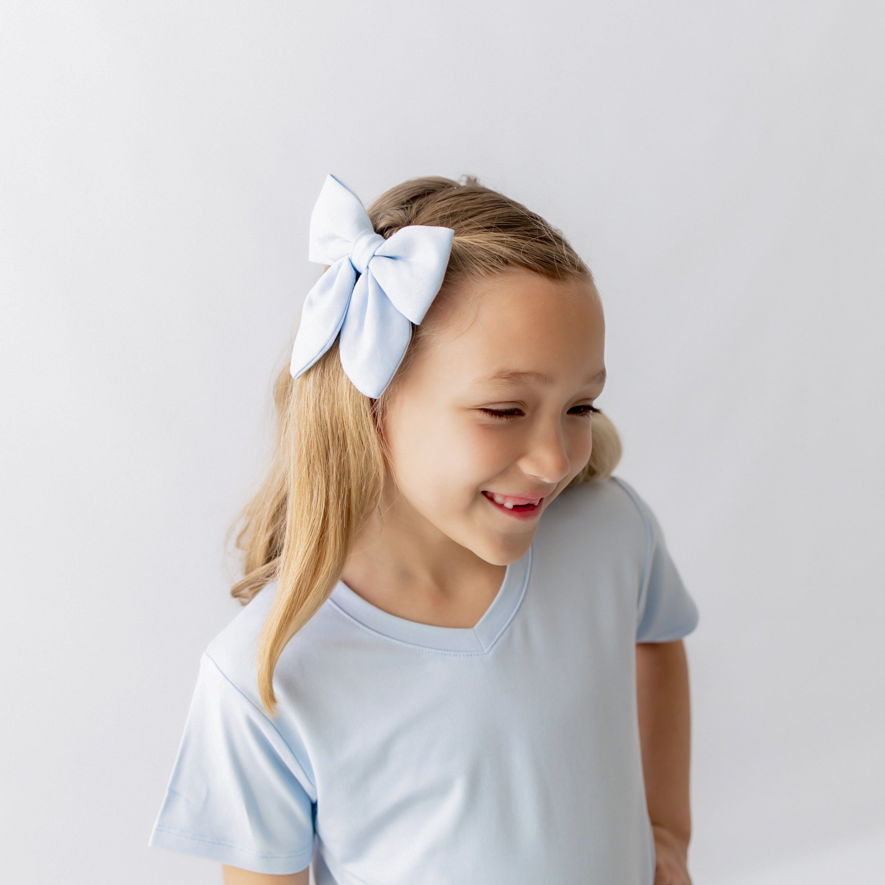 Medium Alligator Clip Bow in Breeze shown in young models hair
