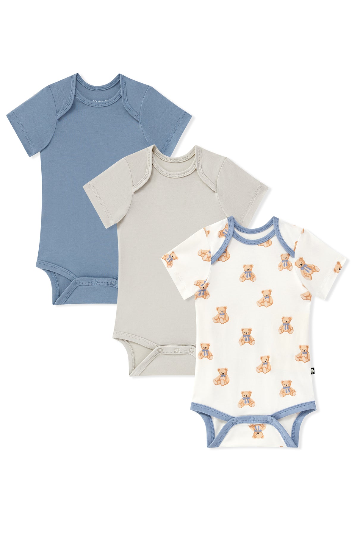 Three short-sleeve baby bodysuits arranged in an overlapping flat lay on a white background: one dusty blue, one light beige, and one white with blue trim and a small orange teddy bear print.