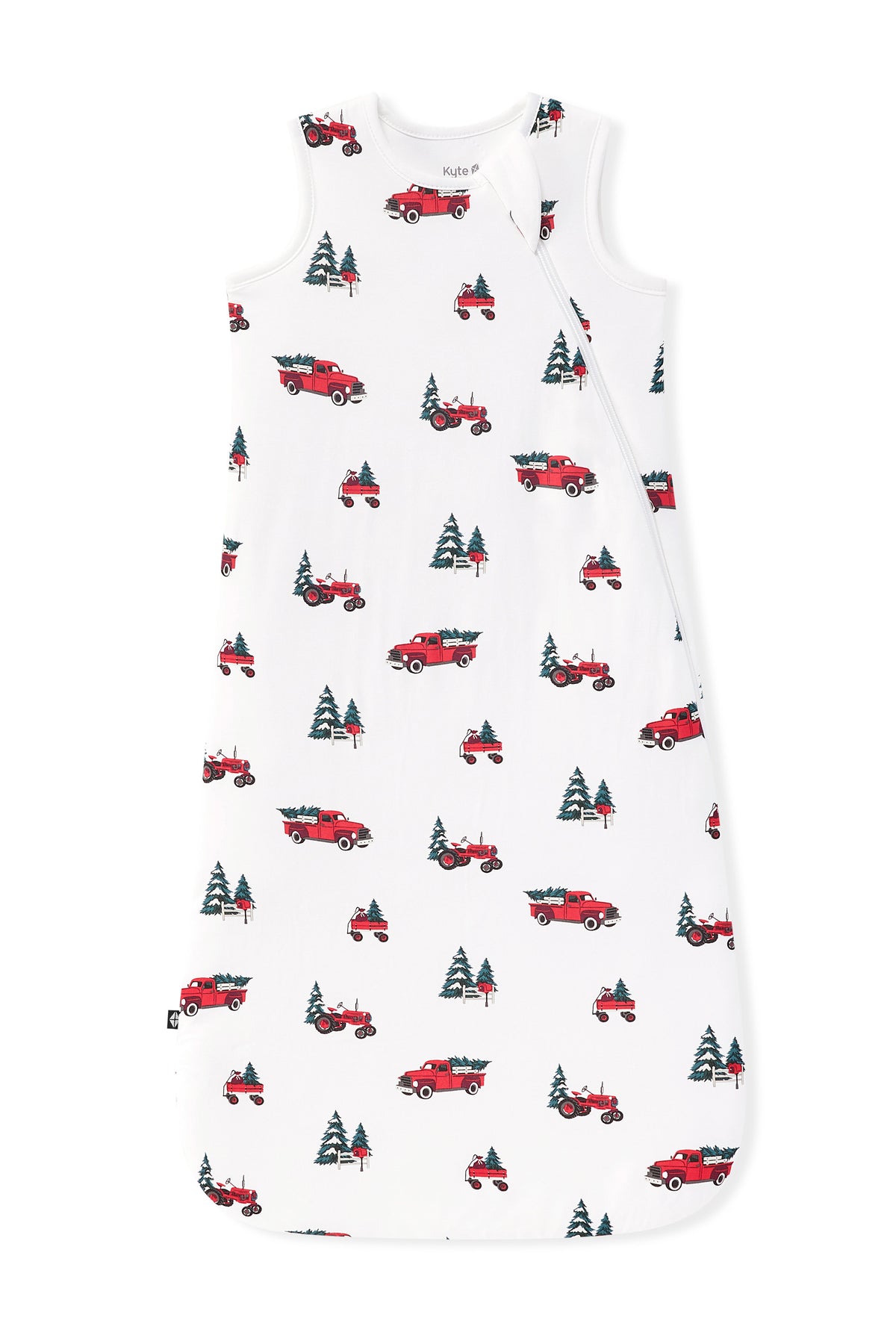 A white sleeveless baby sleep sack featuring an all-over pattern of red pickup trucks carrying Christmas trees, shown flat against a white background.