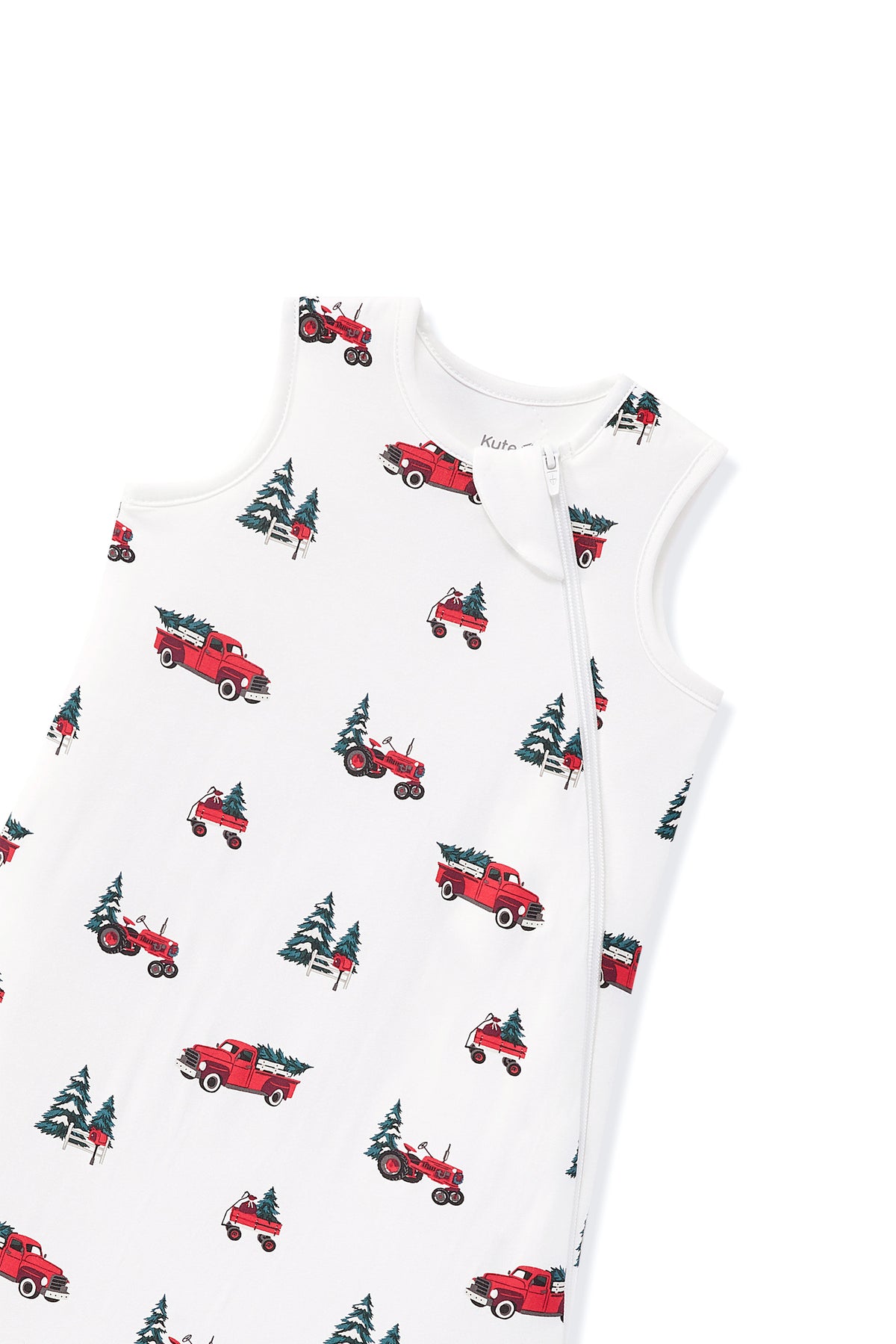 A sleeveless white baby sleep sack with a front zipper, featuring an all-over print of red pickup trucks and green Christmas trees.