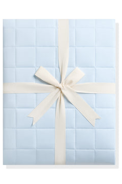 Product photo of the Adult Quilted Blanket in Breeze 2.5 shown tied in its linen ribbon