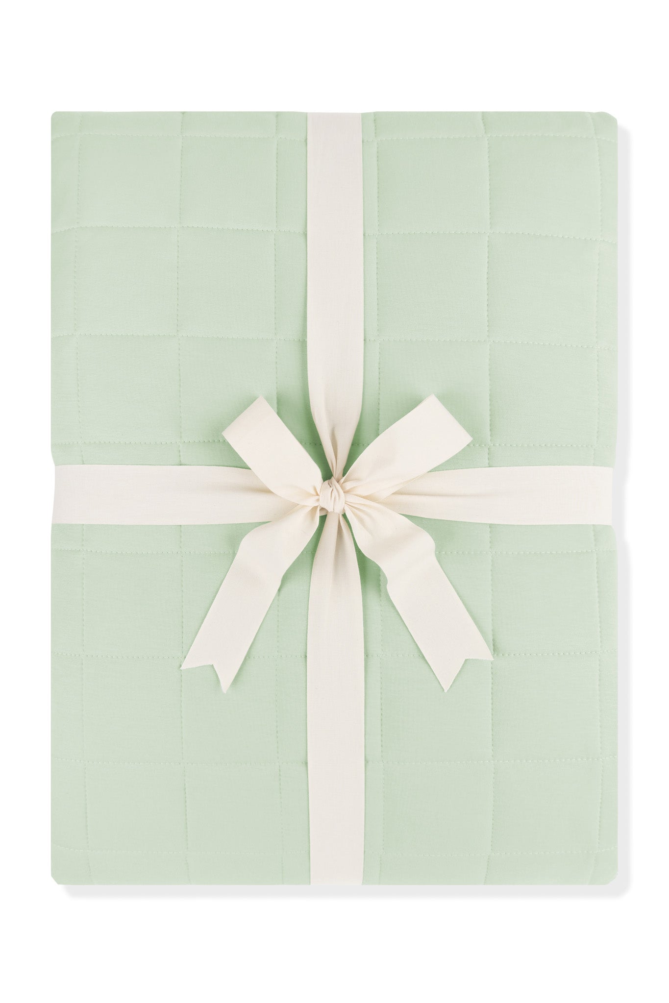 Adult Quilted Blanket in Basil 1.0 shown in its packaging tied with a linen bow