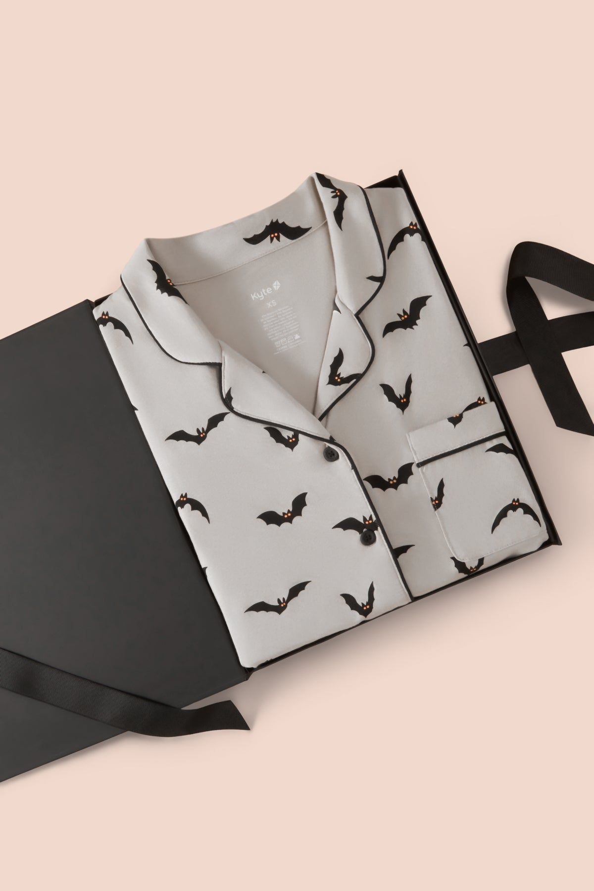 Long-Sleeved Women's Pajama Set in Bats print packed in a box on a beige background