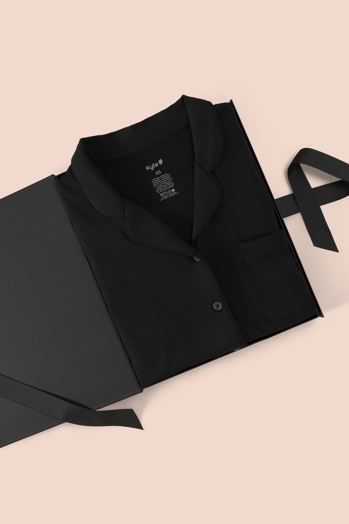 Long-Sleeved Women's Pajama Set in Midnight with Midnight Trim packed in a box on a beige background