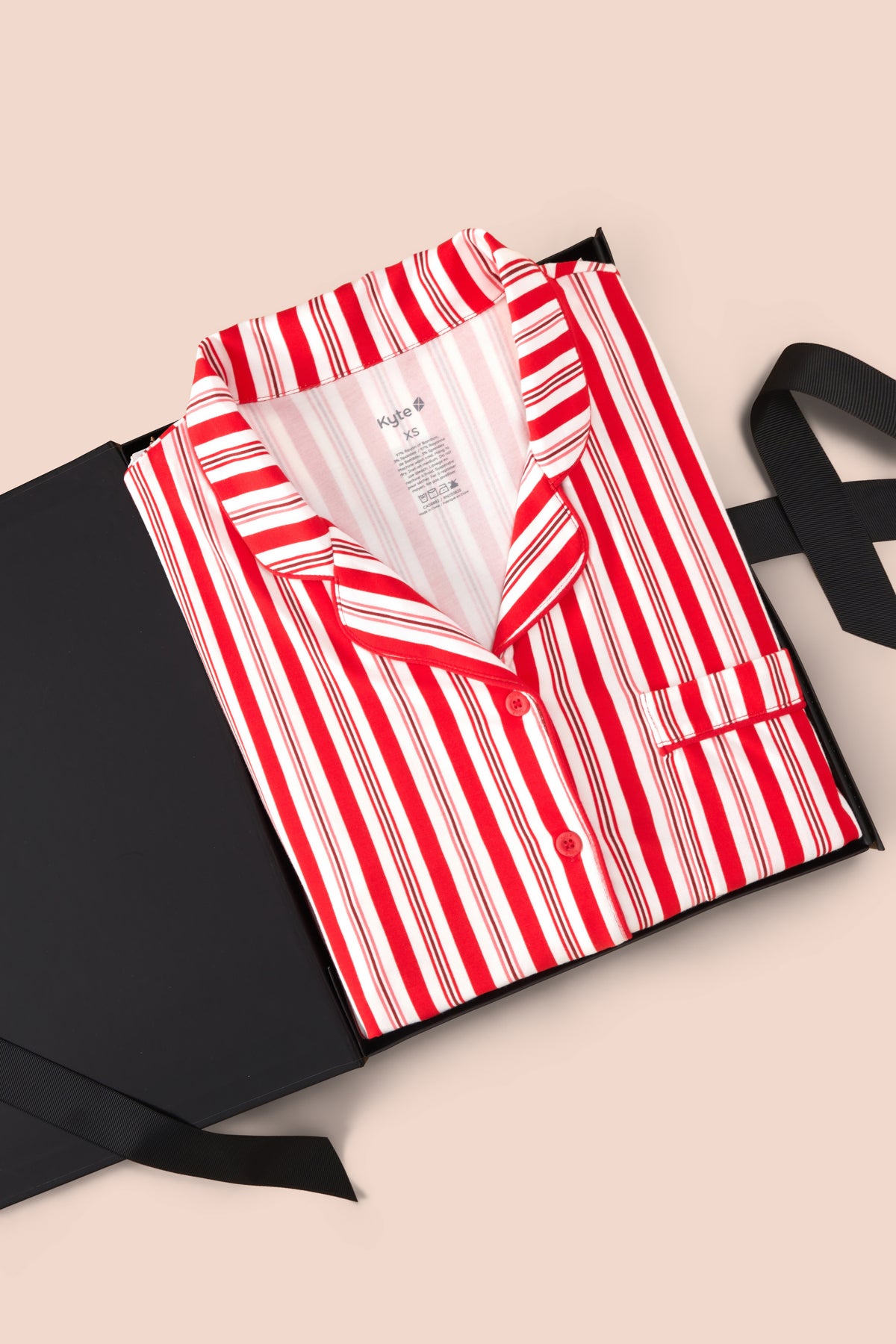 Long-Sleeved Women's Pajama Set in red and white Peppermint Stripes print packed in a box on a beige background