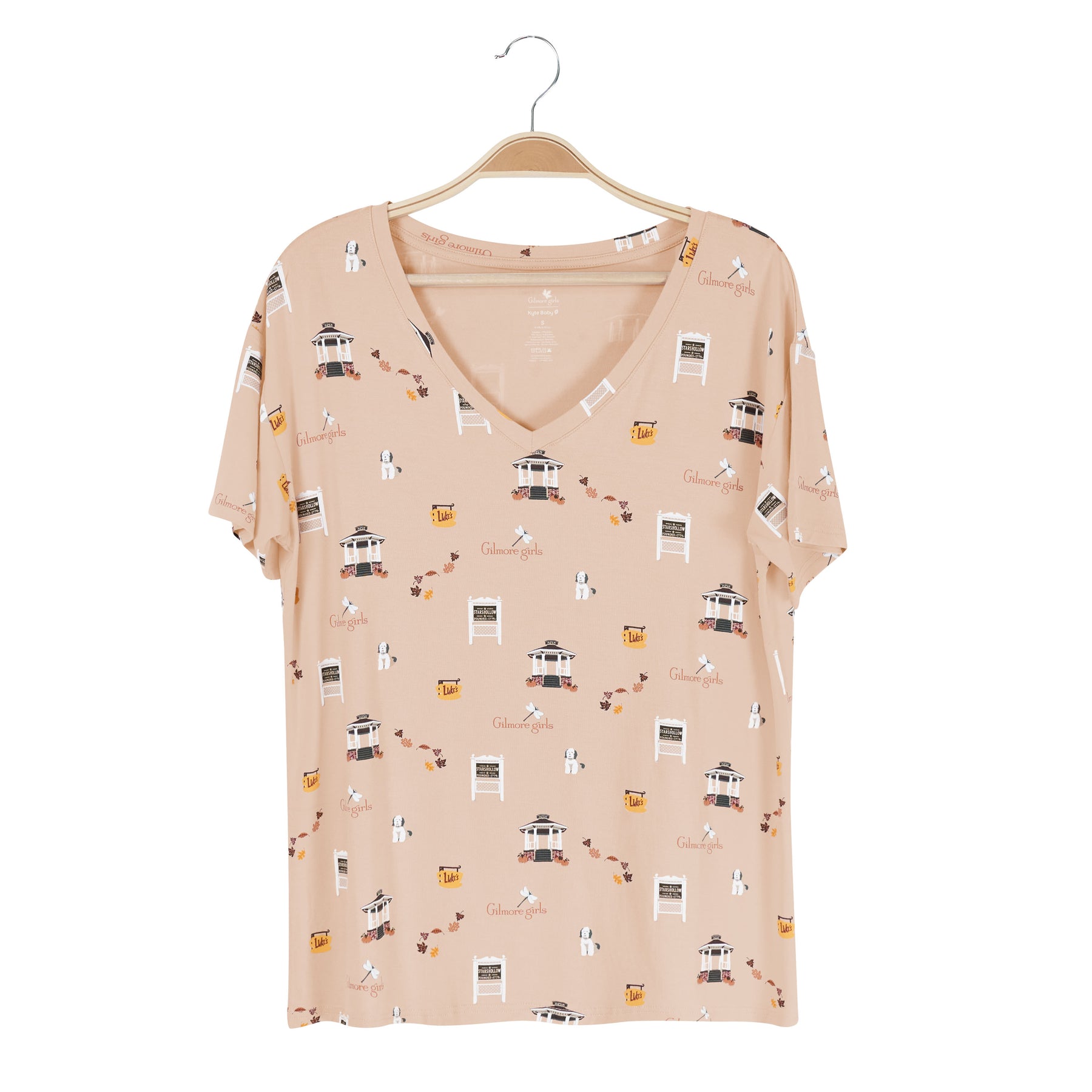 Beige v-neck t-shirt with Gilmore Girls pattern on a wooden hanger against a white background