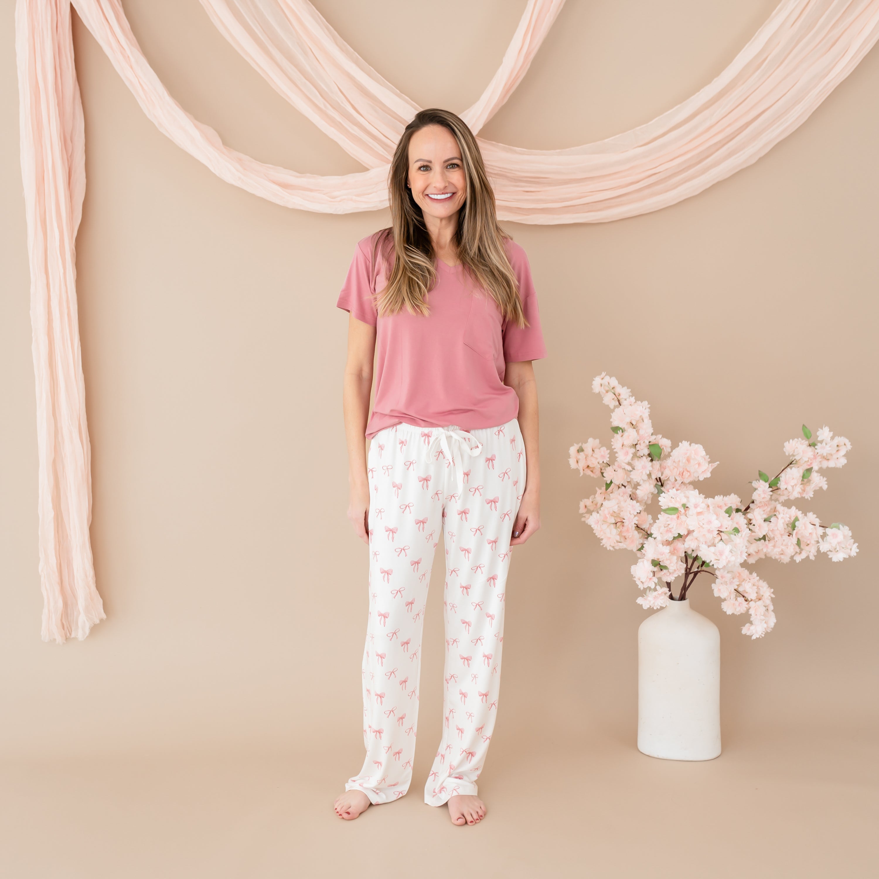 Woman modeling Women's Lounge Pants in Bow with Apple Blossom V-Neck