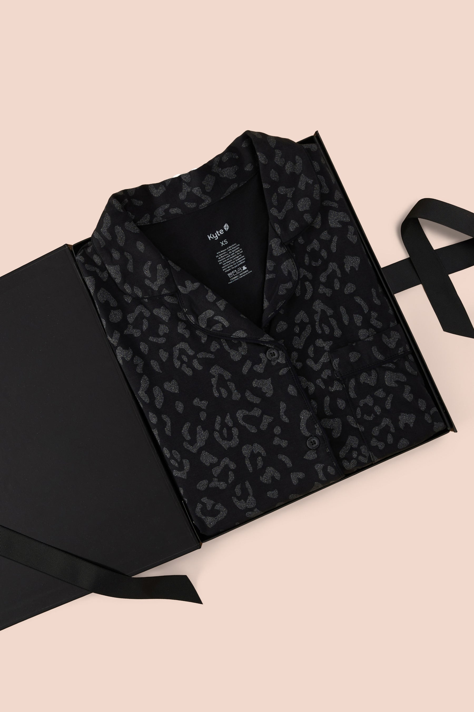 Long-Sleeved Women's Pajama Set in Midnight Leopard print packed in a box on a beige background