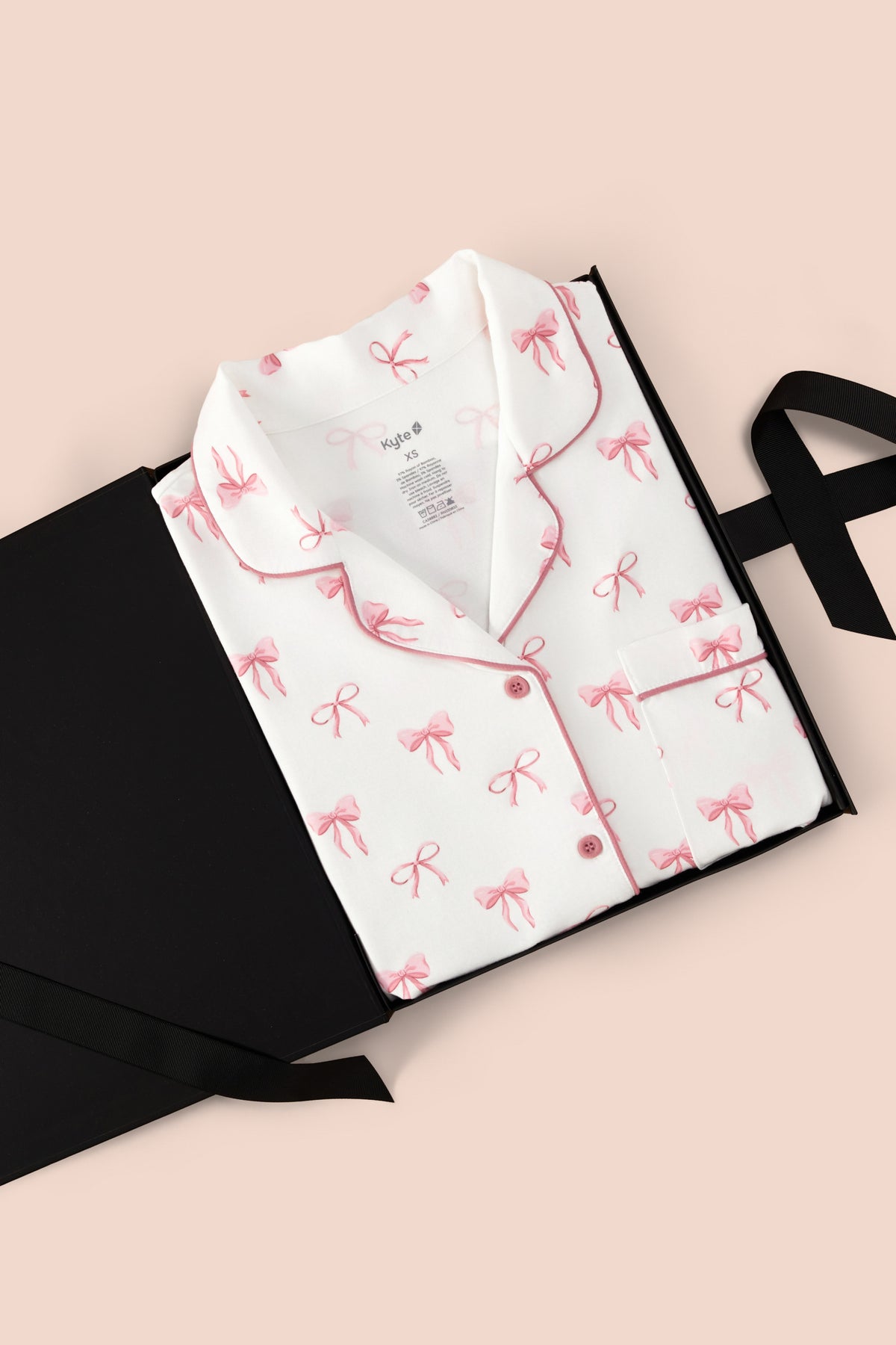 Long-Sleeved Women's Pajama Set in Bow print packed in a box on a beige background