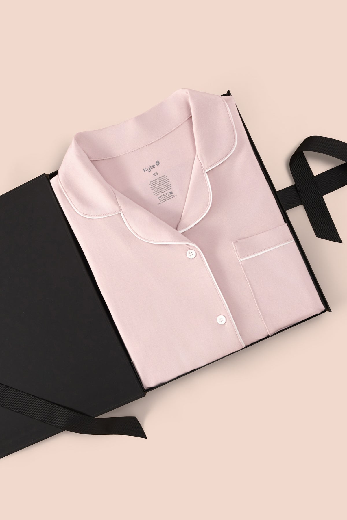 Women’s Short Sleeve Pajama Set in Blush with Cloud Trim packed in a box on a beige background